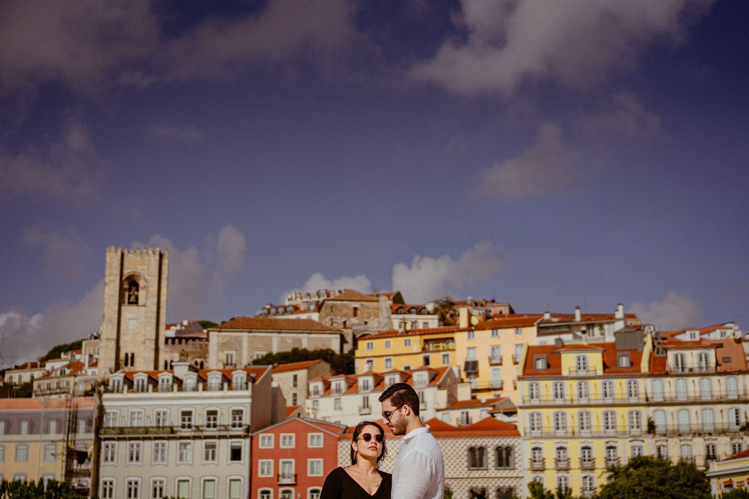 Panoramic view of colorful historic buildings and architecture along the waterfront in Lisbon, Portugal on a sunny day.