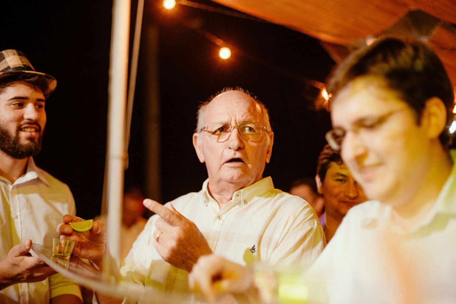 A series of candid nighttime bar photos showing patrons lit by warm overhead lighting in casual conversation.