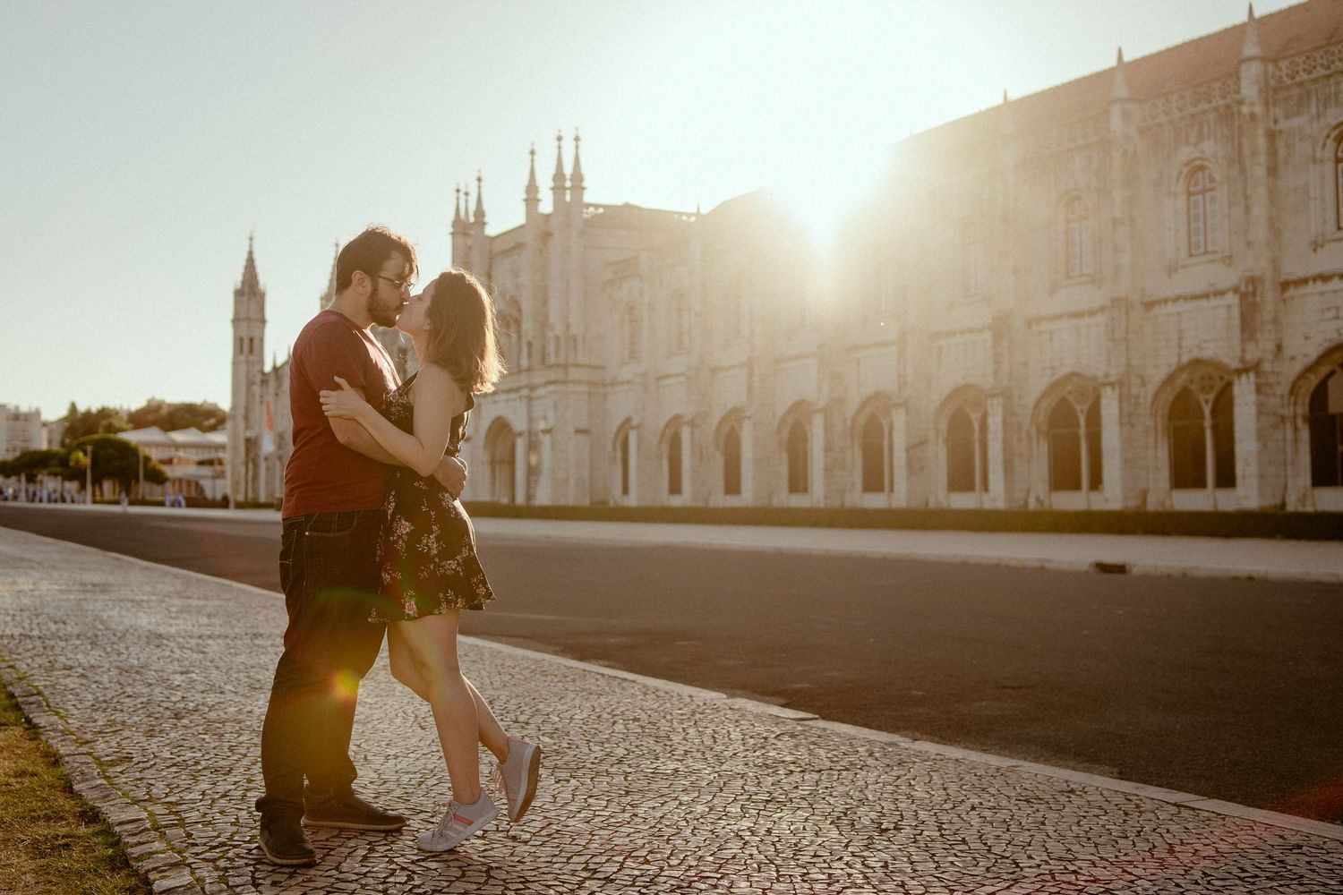 A collection of romantic photos at sunset showing couples embracing in European city squares and cobblestone streets.