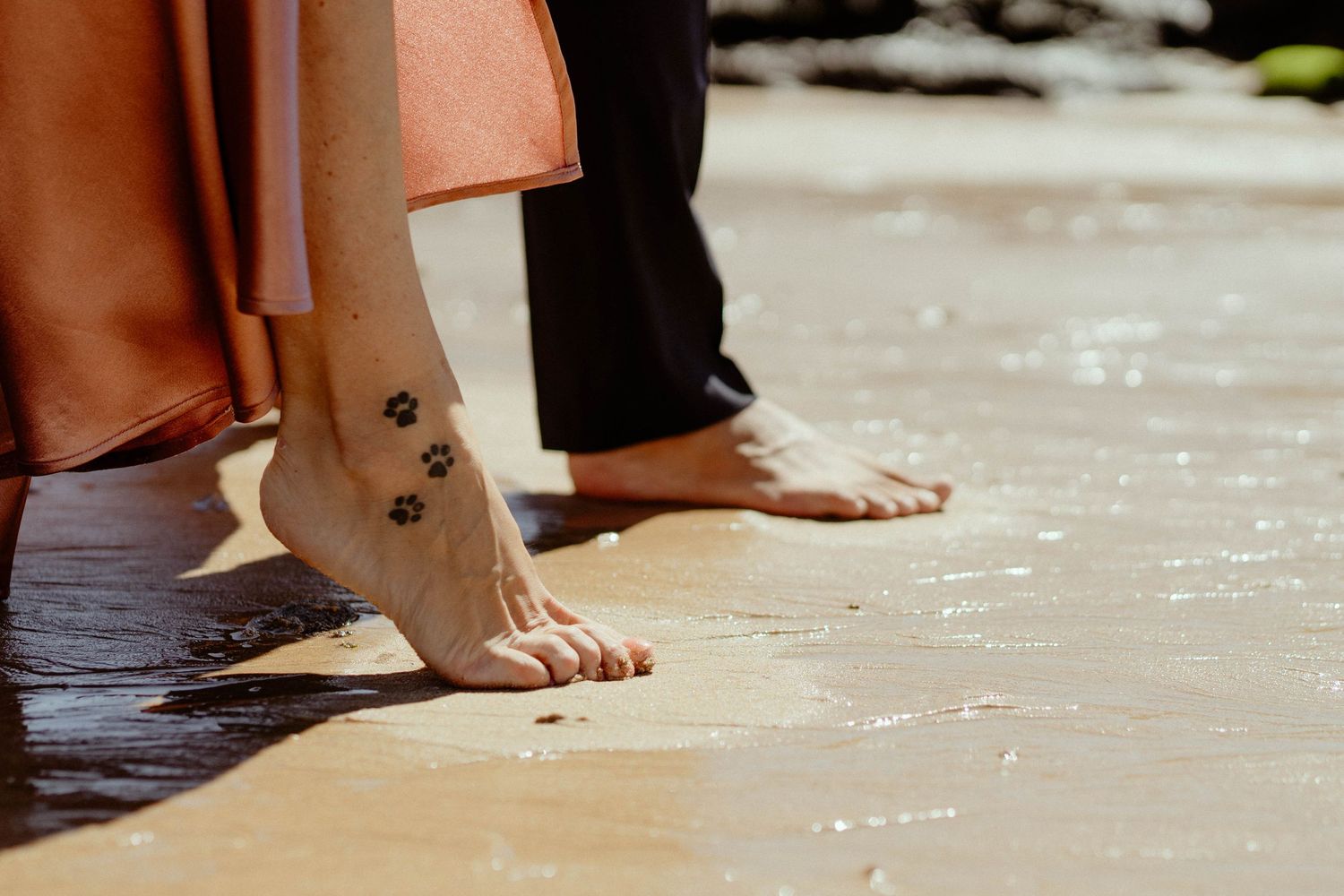 A row of bare feet standing on a light colored floor in various positions and angles.