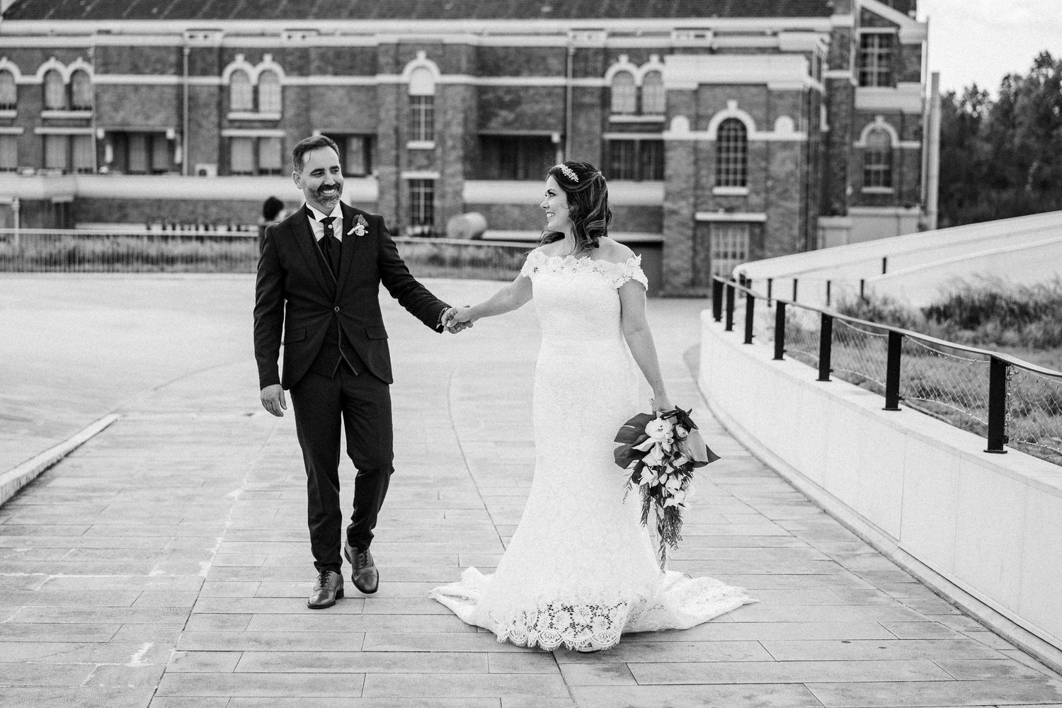 A sequence of black and white wedding photographs showing a couple walking while the dress billows in the wind.