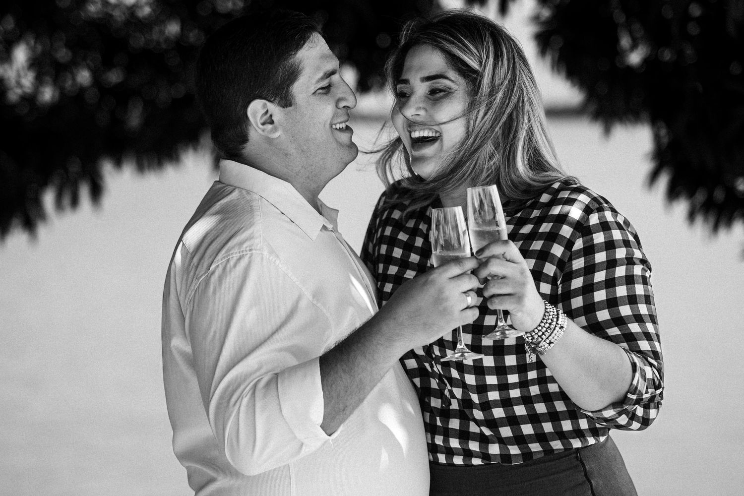 Black and white romantic photo series of a couple dancing together in a meadow.