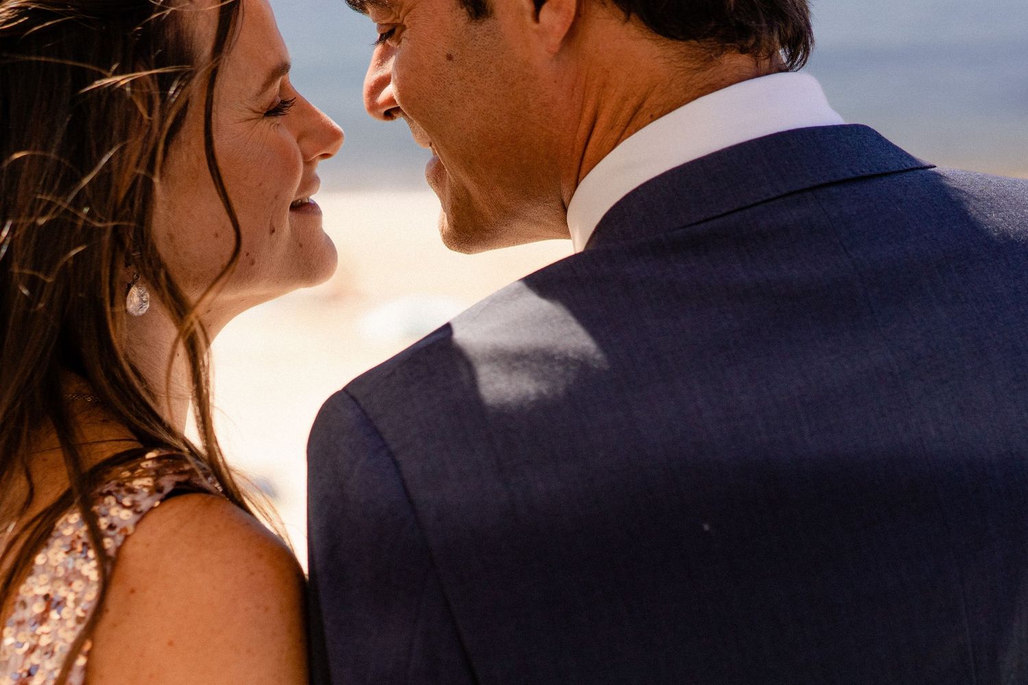 A romantic close-up moment between newlyweds during golden hour.
