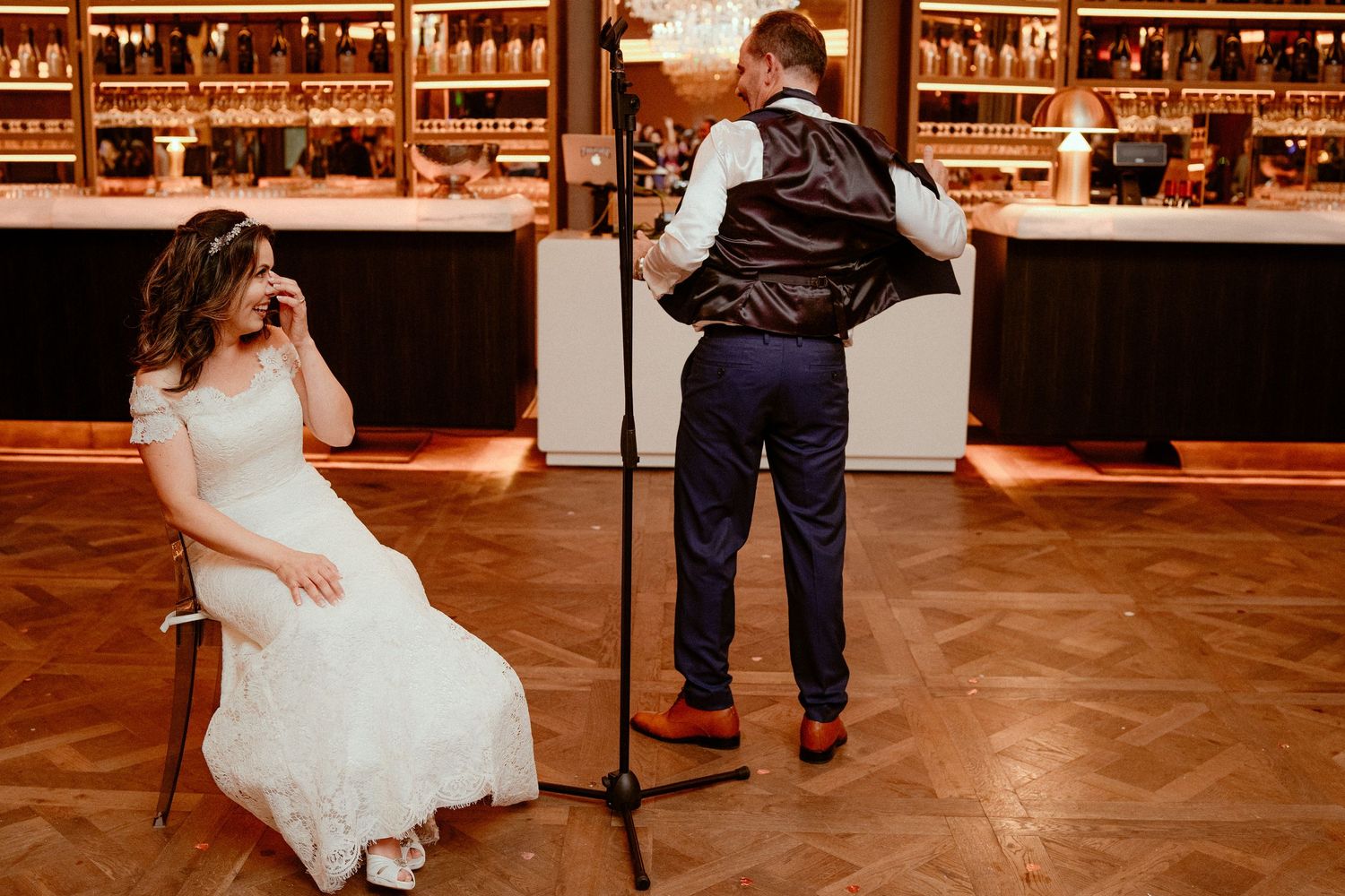 A collection of wedding reception dance floor moments showing couples dancing at a rustic venue with warm ambient lighting.