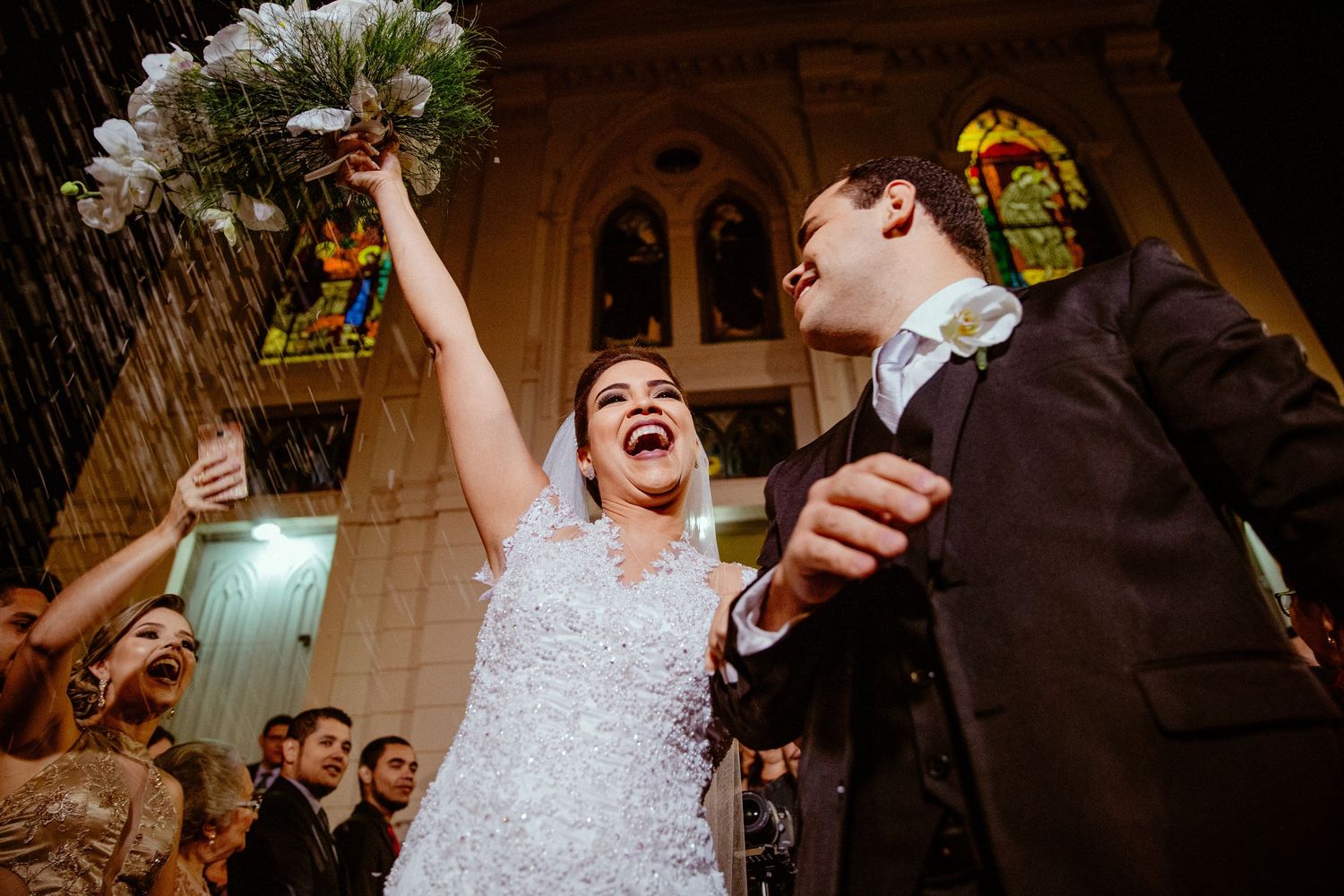 Candid celebration moment at wedding reception with dancing and laughter.