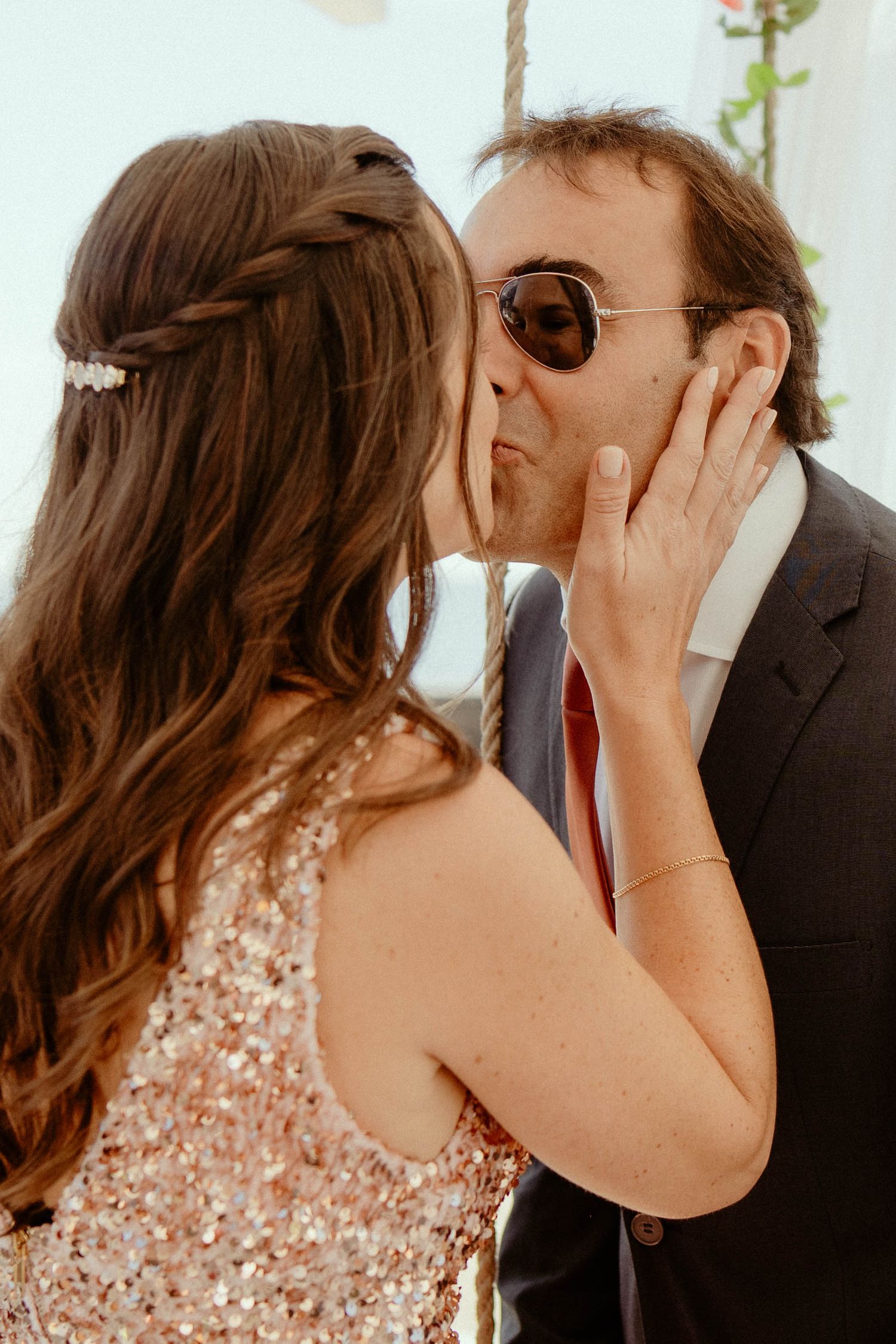 A romantic sequence of wedding photos showing a couple in formal attire sharing intimate kisses.