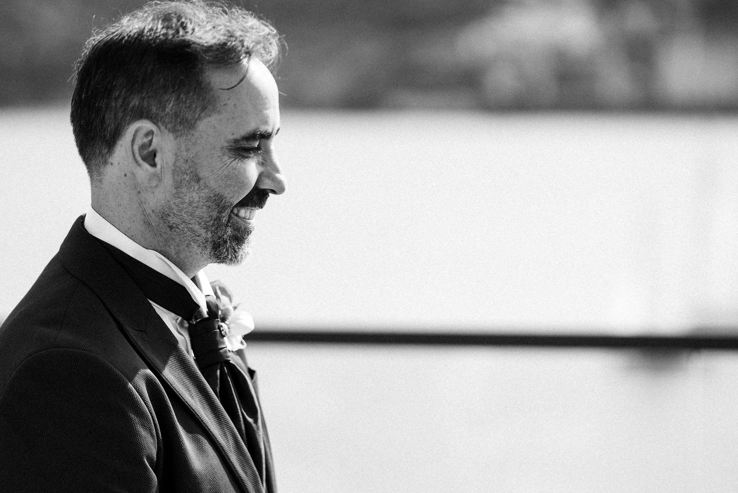 Black and white profile portrait showing emotional moment during a wedding ceremony.