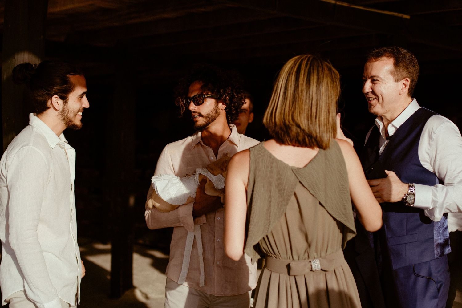 People in formal attire dance and socialize at an elegant evening event.