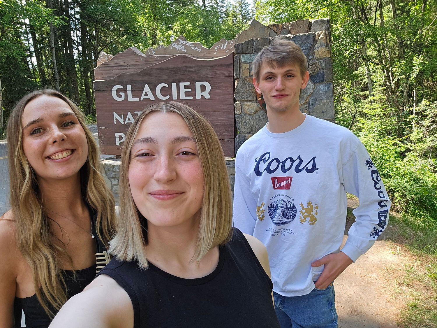 Emma Beth Photo and photo/video team at the entrance of Glacier National Park days prior to covering a Montana micro-wedding and adventure.