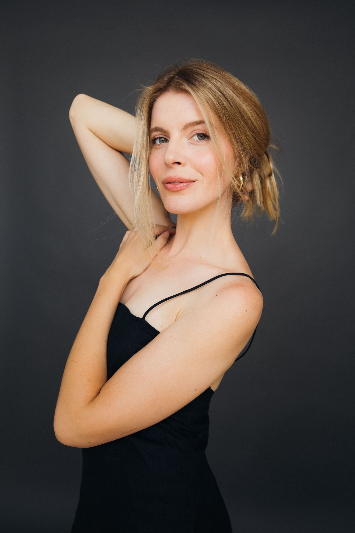 Natural model portfolio portraits of woman with dark backdrop posed in Santa Monica studio by photographer Phia Photography.