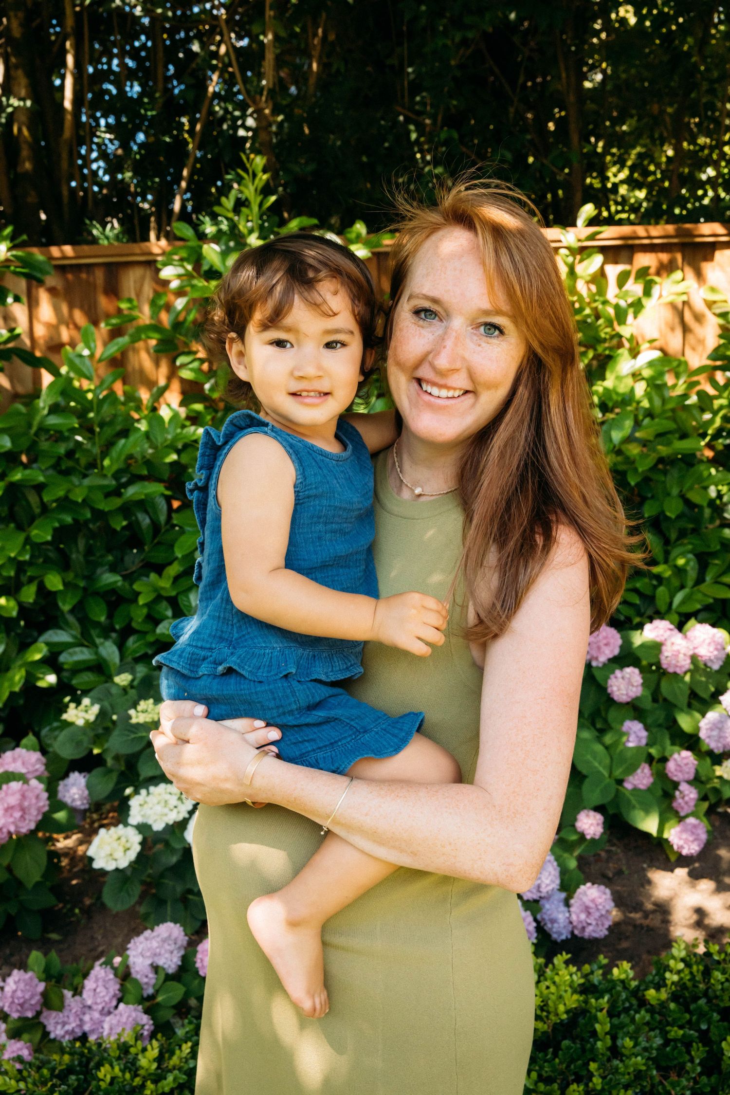 Natural light outdoor lifestyle portrait of pregnant mother holding child by Los Angeles editorial family photographer Phia Photography.