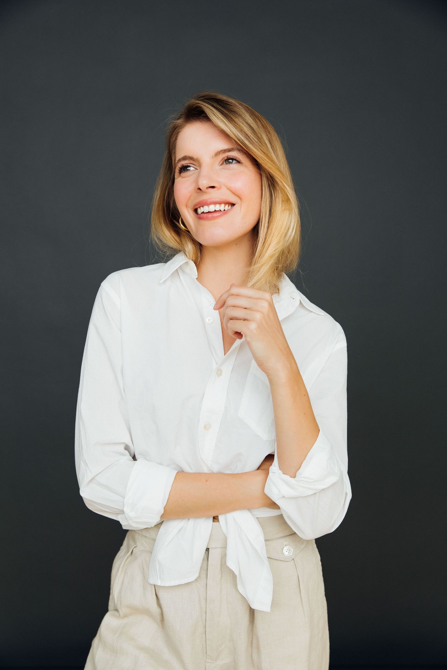 Editorial headshot of woman in white shirt dark backdrop for professional branding Santa Monica studio by photographer Phia Photography.