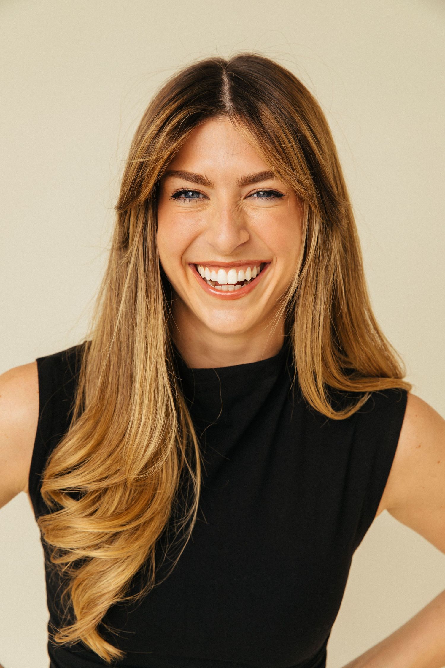 Natural light headshot of smiling creative woman in Los Angeles studio by LA editorial photographer Phia Photography.