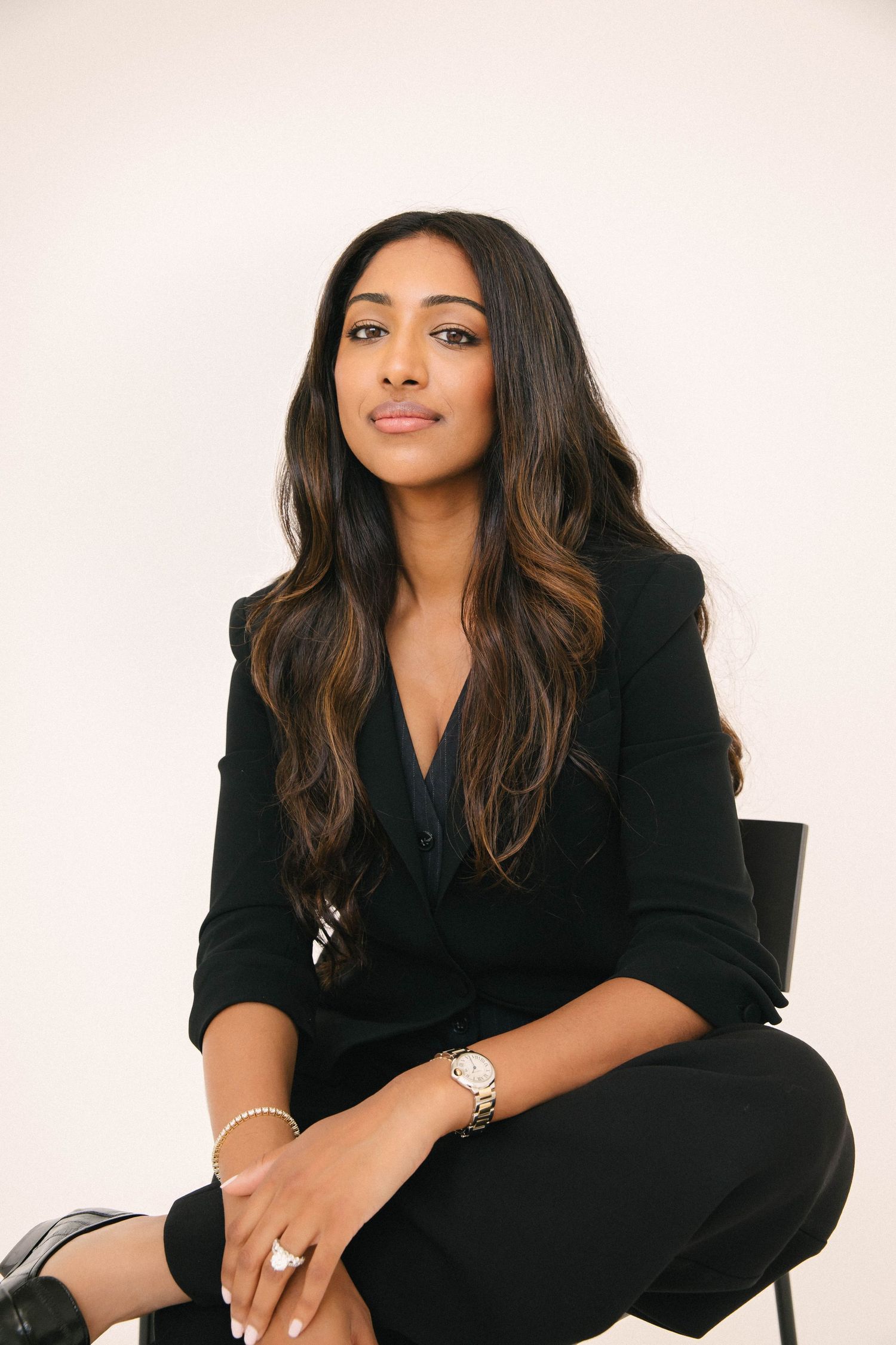 Natural light headshot portrait of professional woman in black blazer sitting in Santa Monica studio by LA photographer Phia Photography.