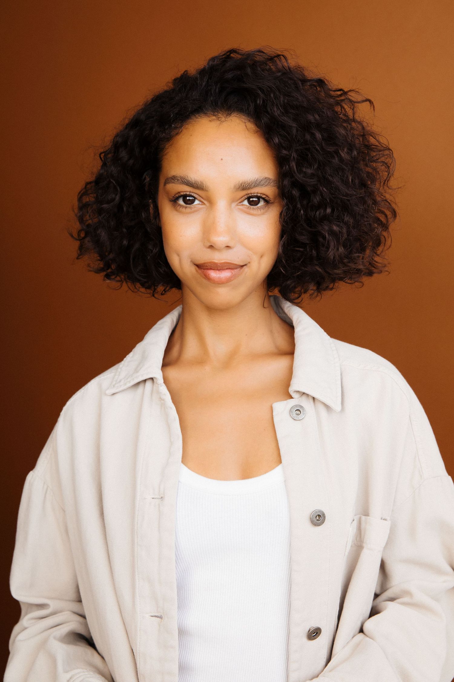 Creative actor headshot of black woman with brown backdrop in Santa Monica studio by Los Angeles photographer Phia Photography.