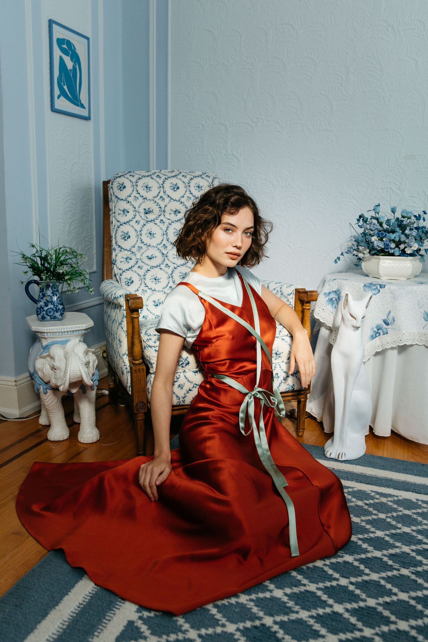 Model portfolio fashion portrait of woman posed sitting at vintage home by Los Angeles editorial photographer Phia Photography.