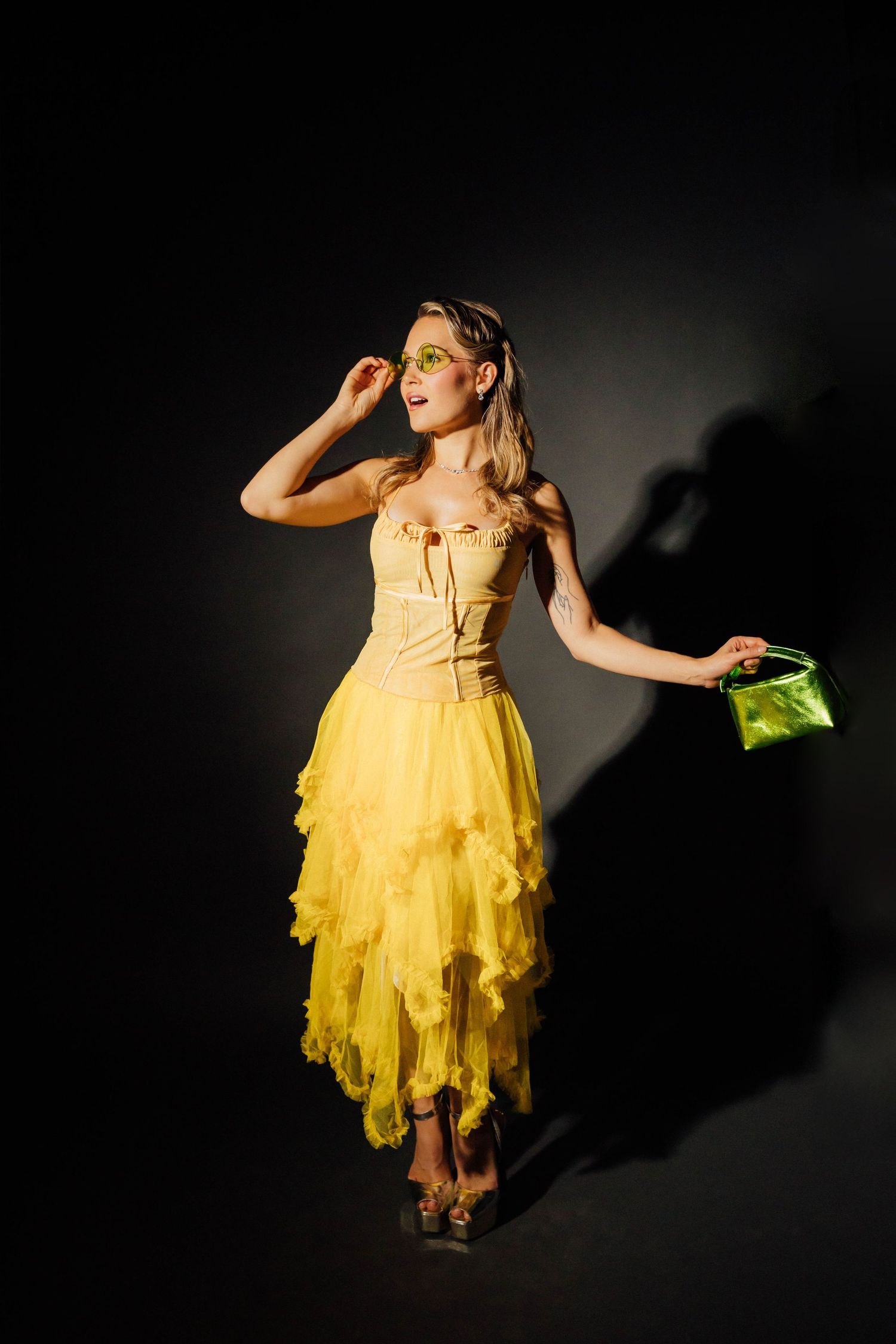 Editorial model portraits of a woman standing in a yellow dress at Santa Monica studio by creative Los Angeles photographer Phia Photography