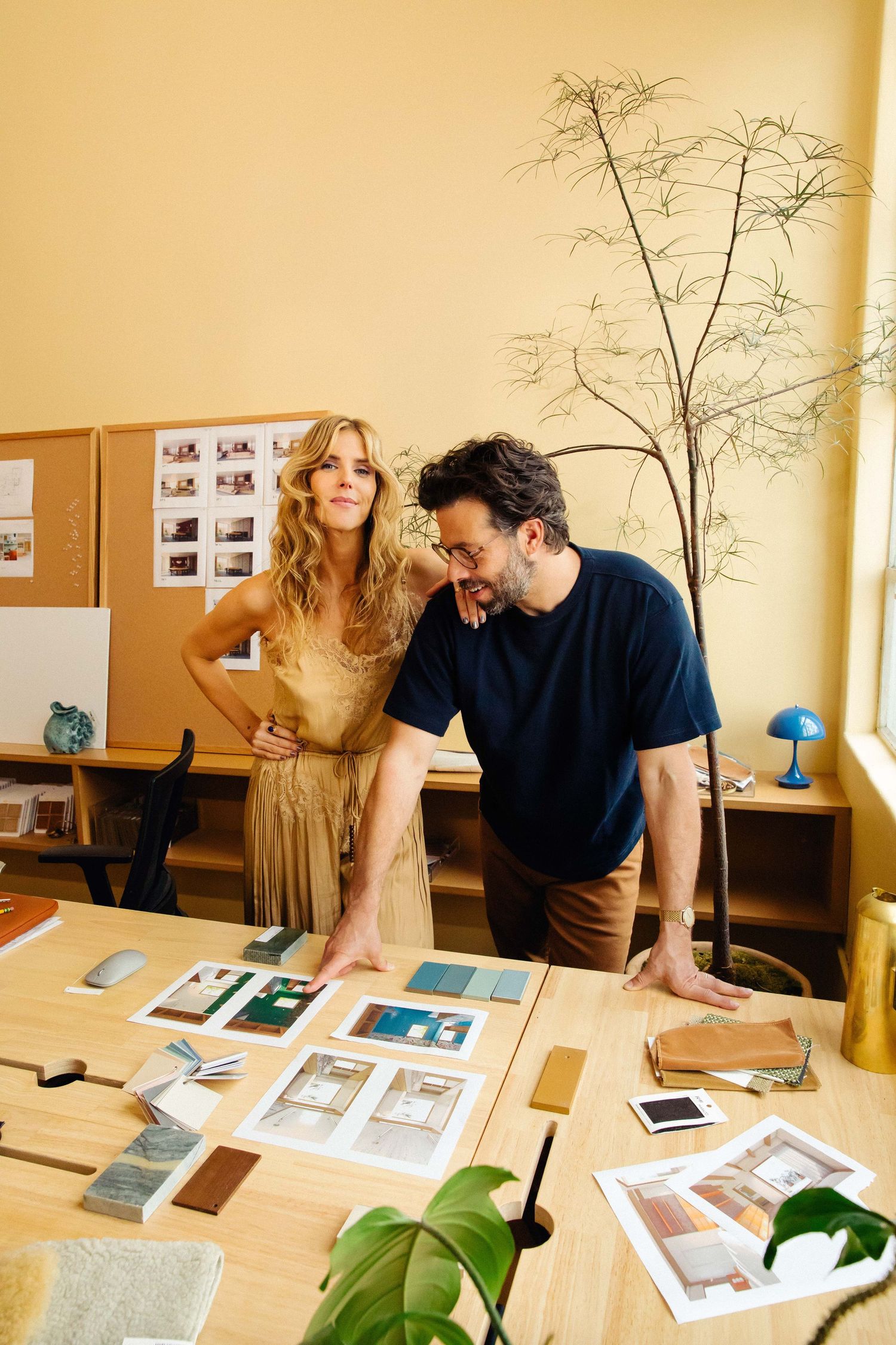 Editorial personal branding portrait of creative man and woman reviewing work together in warm Los Angeles office by Phia Photography.