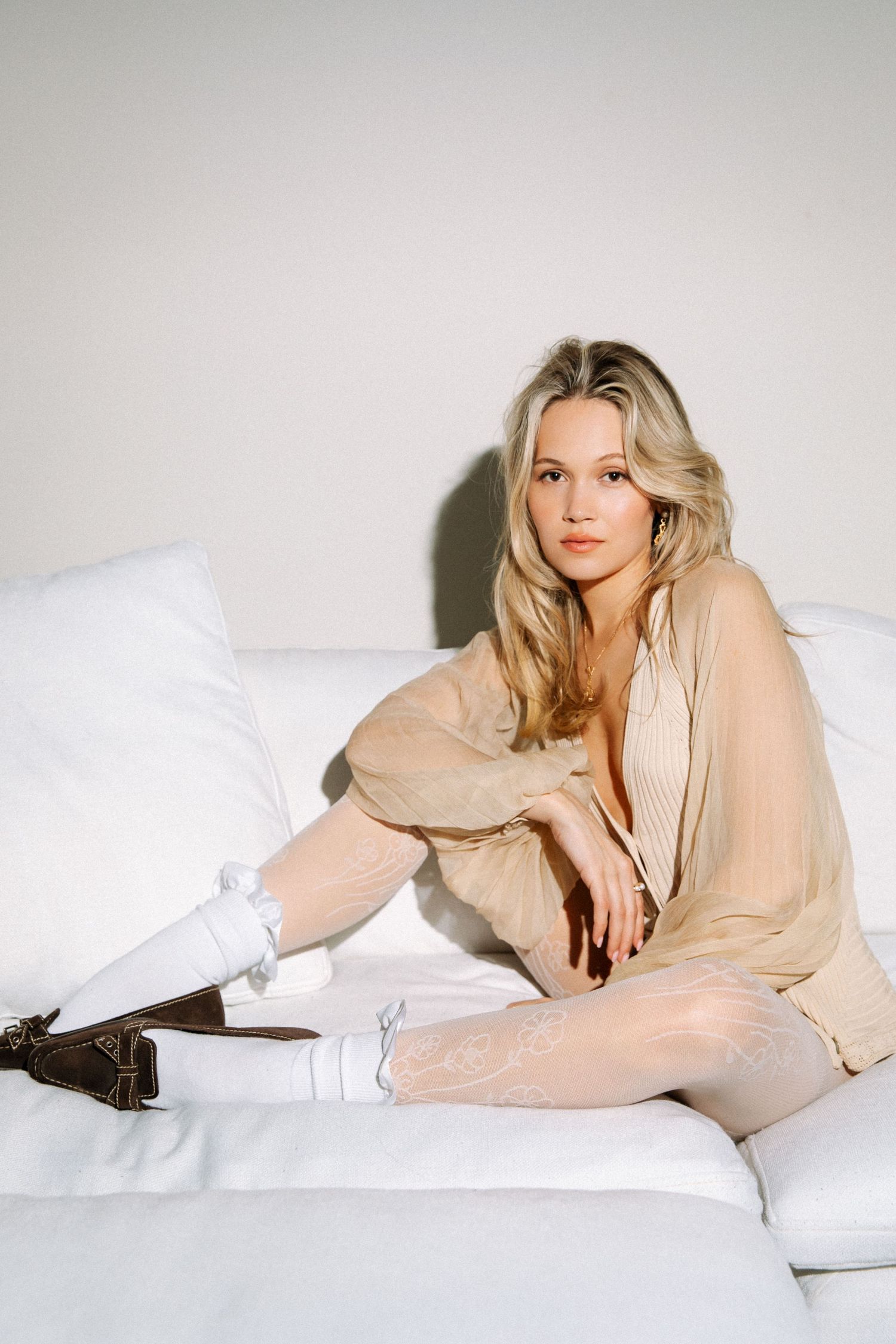 Editorial model portfolio portrait of woman posed on couch by Los Angeles photographer Phia Photography.