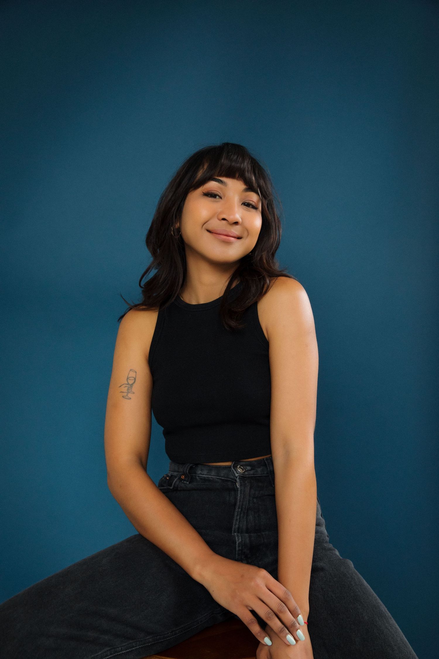 Creative natural light portrait of professional model with navy backdrop in Santa Monica studio by LA photographer Phia Photography.