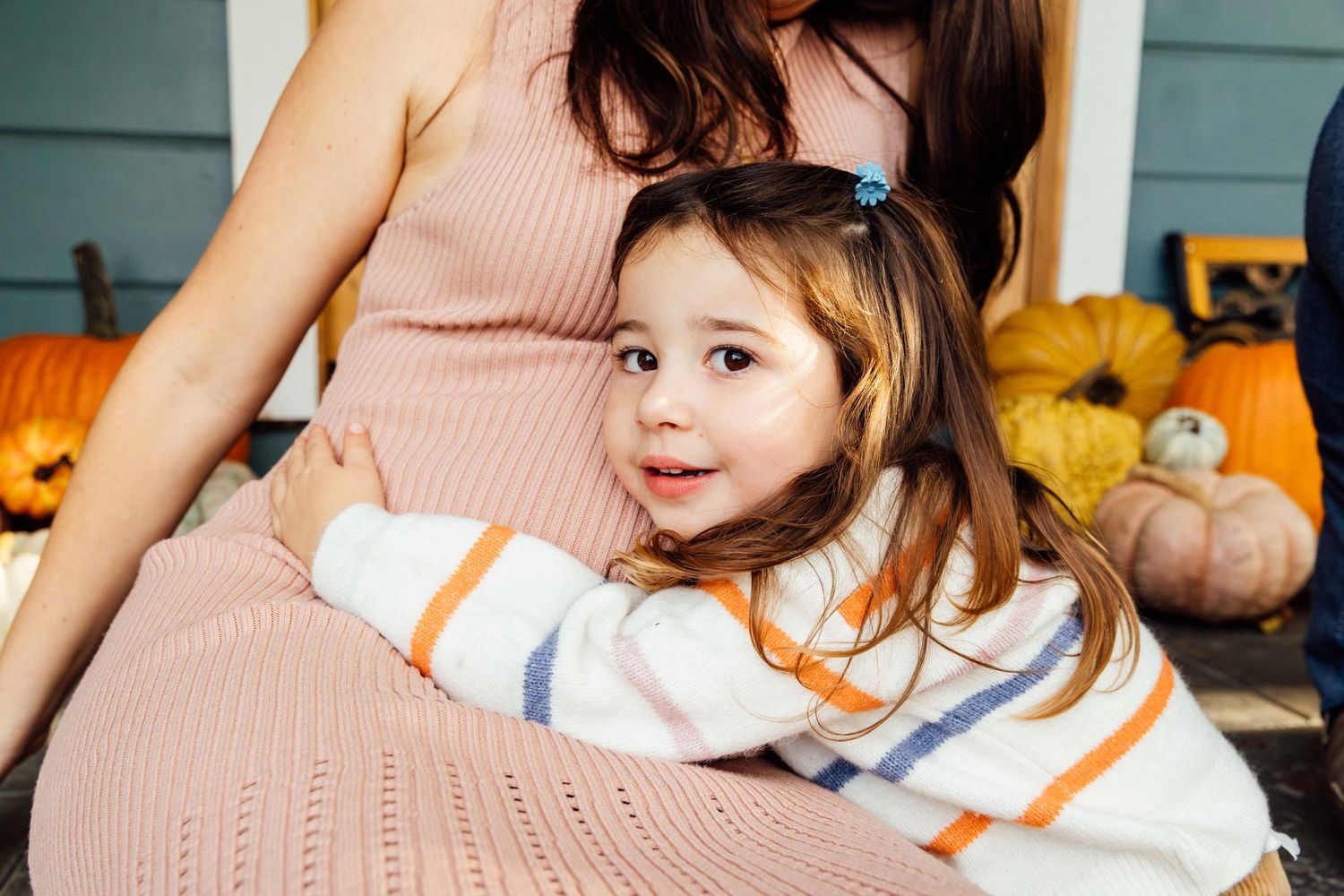 Toddler girl hugging pregnant mom, maternity and family photography Santa Monica by creative editorial photographer Phia Photography