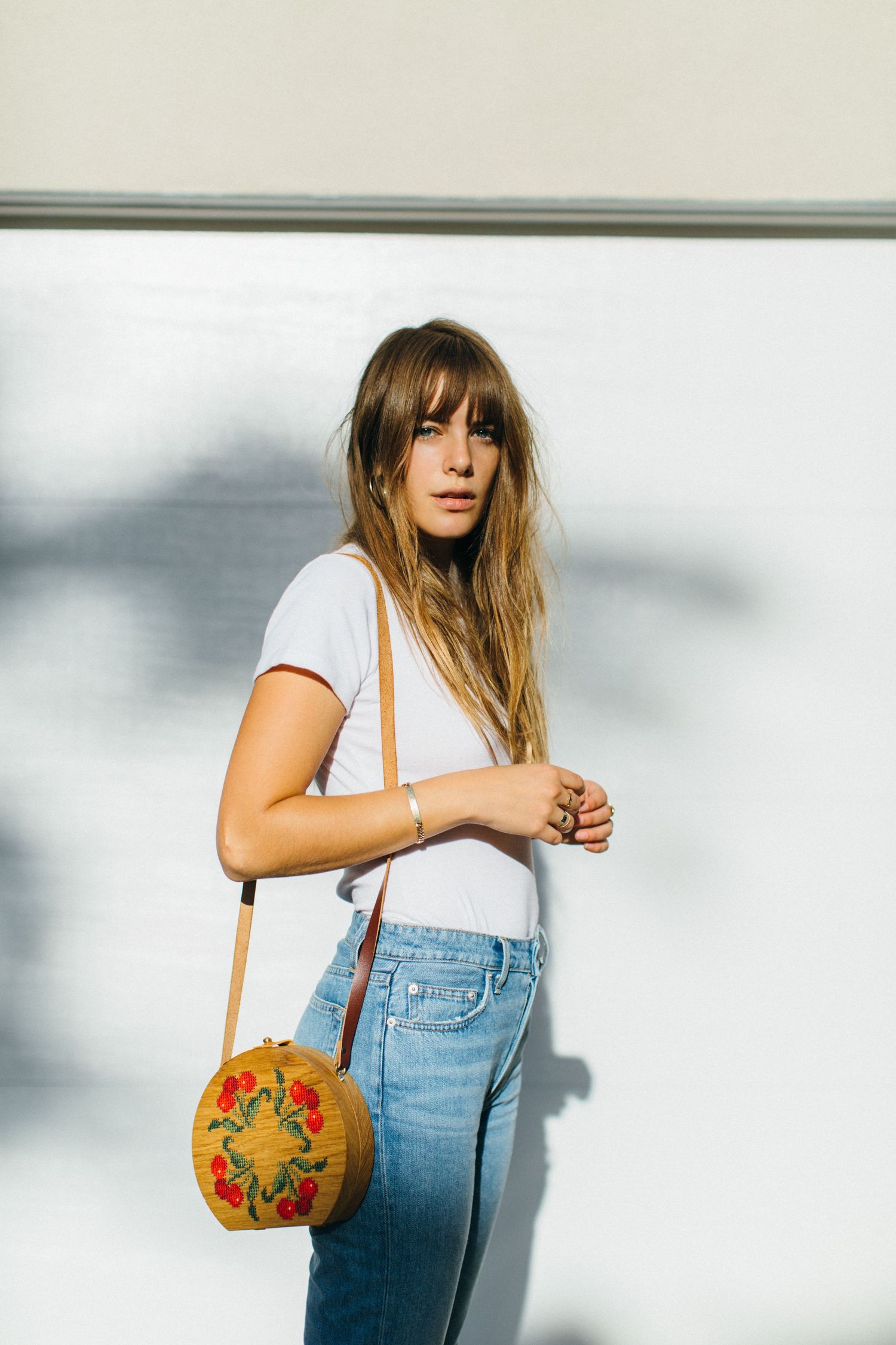 Lifestyle model test portfolio shoot of woman in denim holding bag outside in Santa Monica natural light by LA photographer Phia Photography