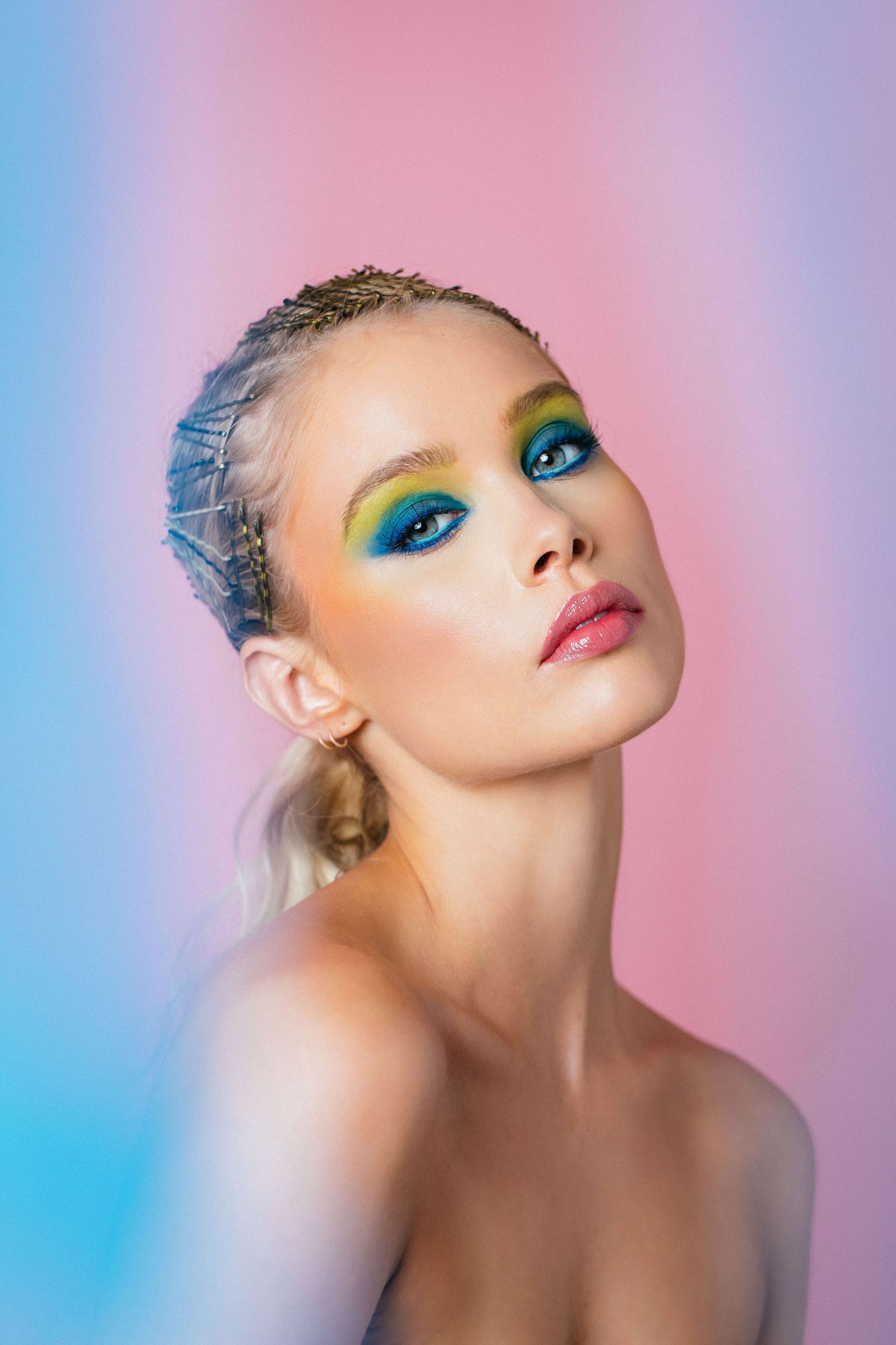 Editorial beauty model headshot of woman in creative hair and makeup with pink background by LA photographer Phia Photography.