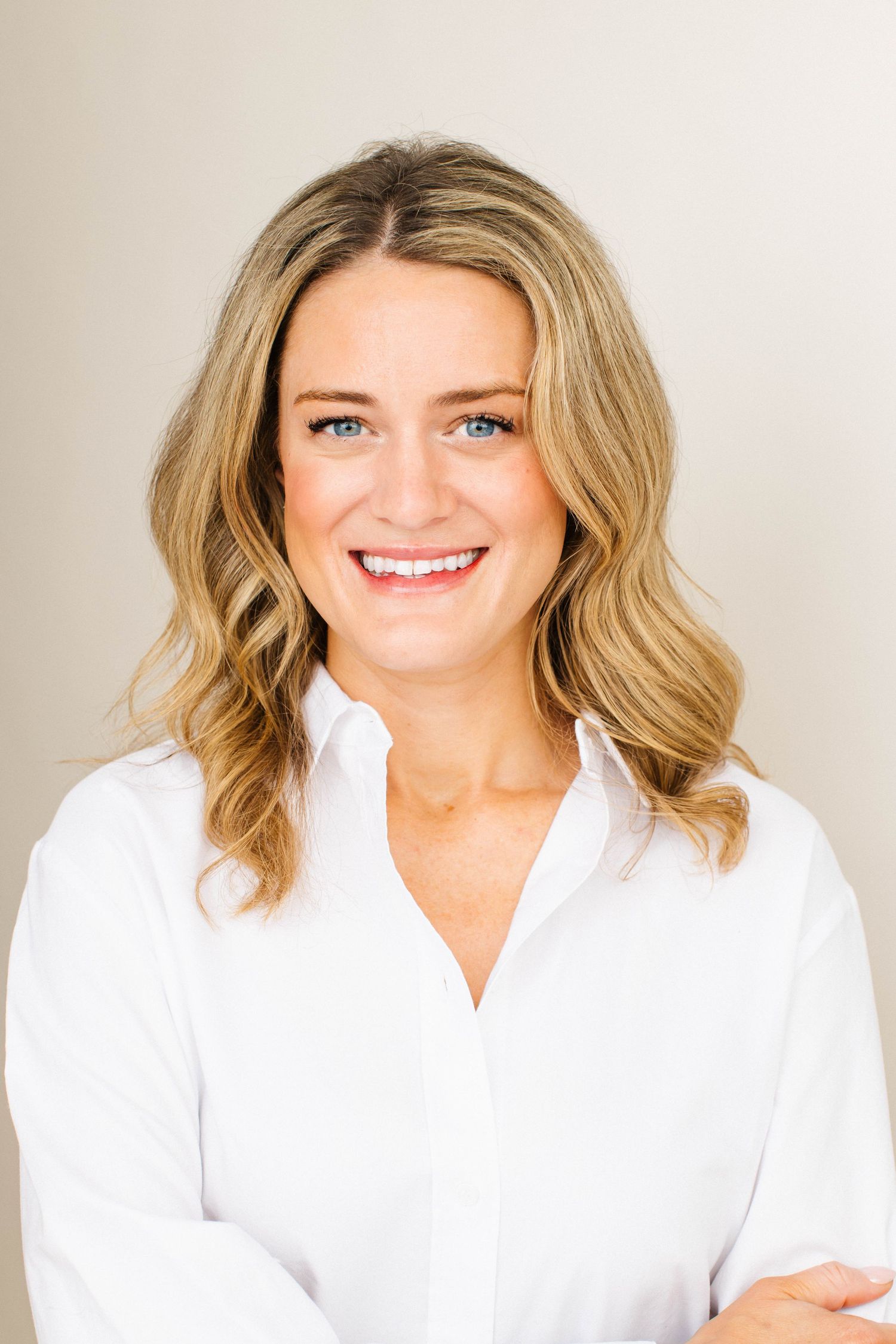 Linkedin headshot of professional woman smiling in a white shirt at a Santa Monica studio by Los Angeles photographer Phia Photography.