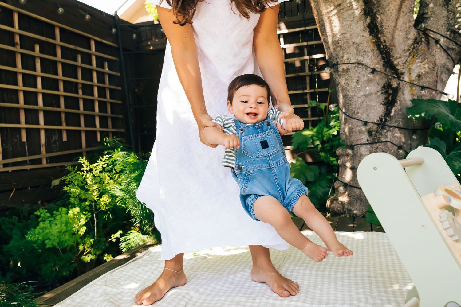 Outdoor lifestyle documentary portrait of mother playing with child in natural light by LA editorial & family photographer Phia Photography.