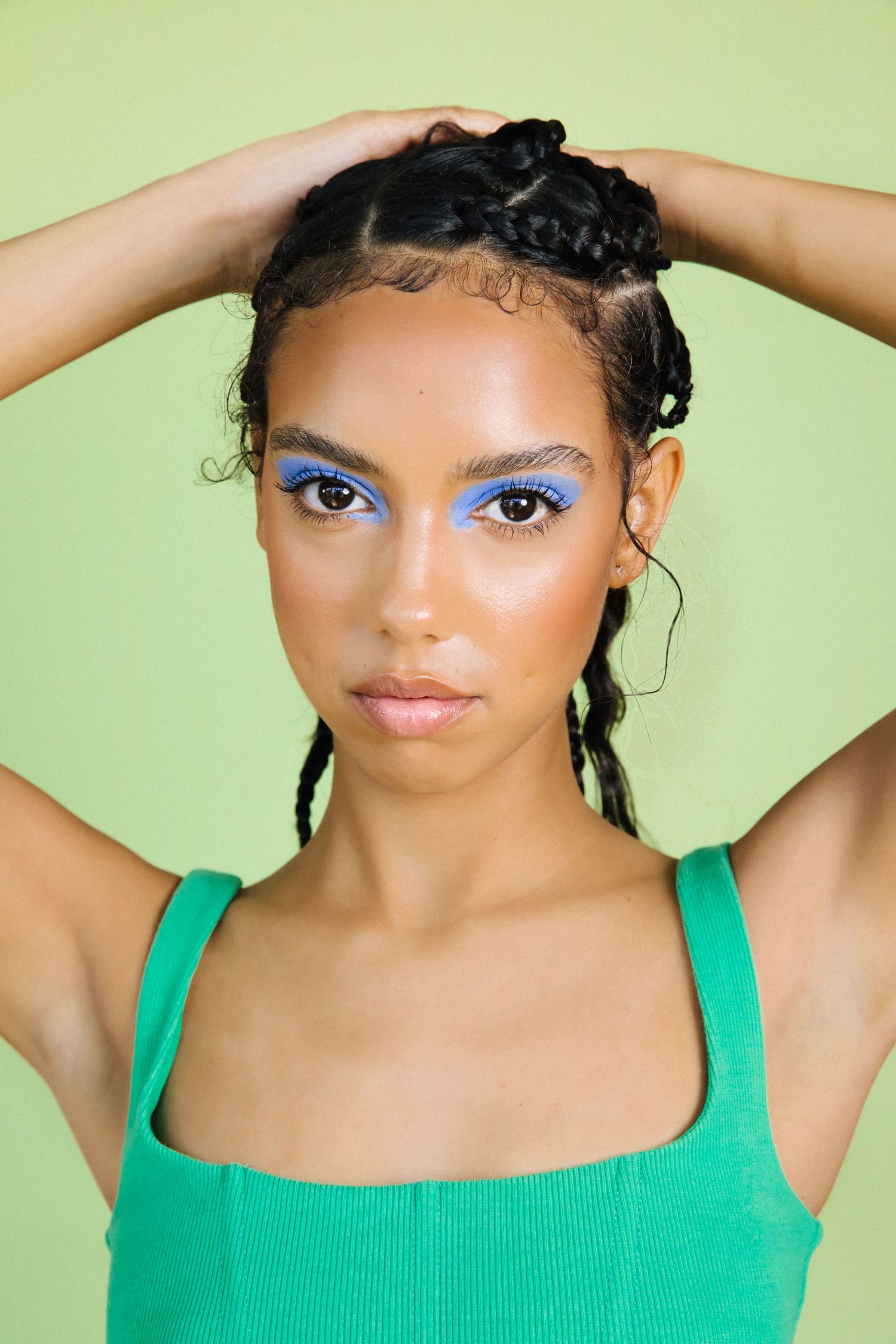 Creative studio model portraits of Black woman with green backdrop and editorial makeup by Los Angeles photographer Phia Photography.