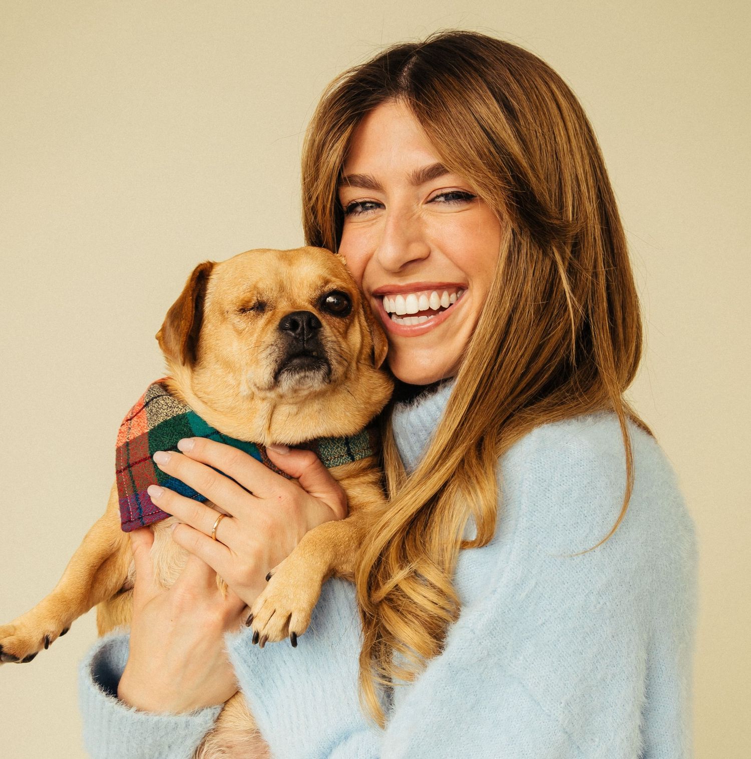 Natural light pet friendly headshot portrait of happy woman hugging small dog in Santa Monica studio by Phia Photography.