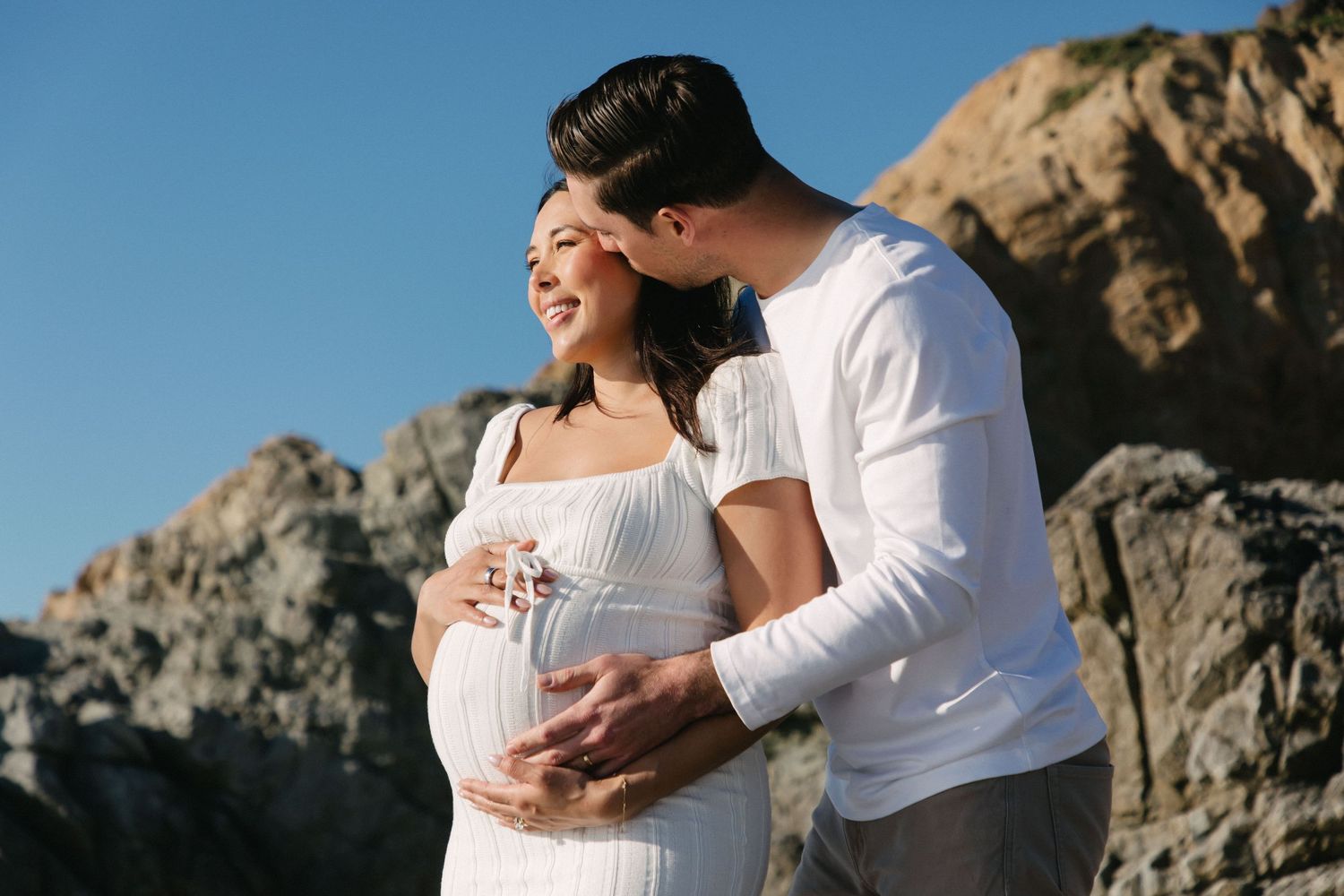 Editorial maternity photos of pregnant mother and father at beach in natural light by Los Angeles family photographer Phia Photography.