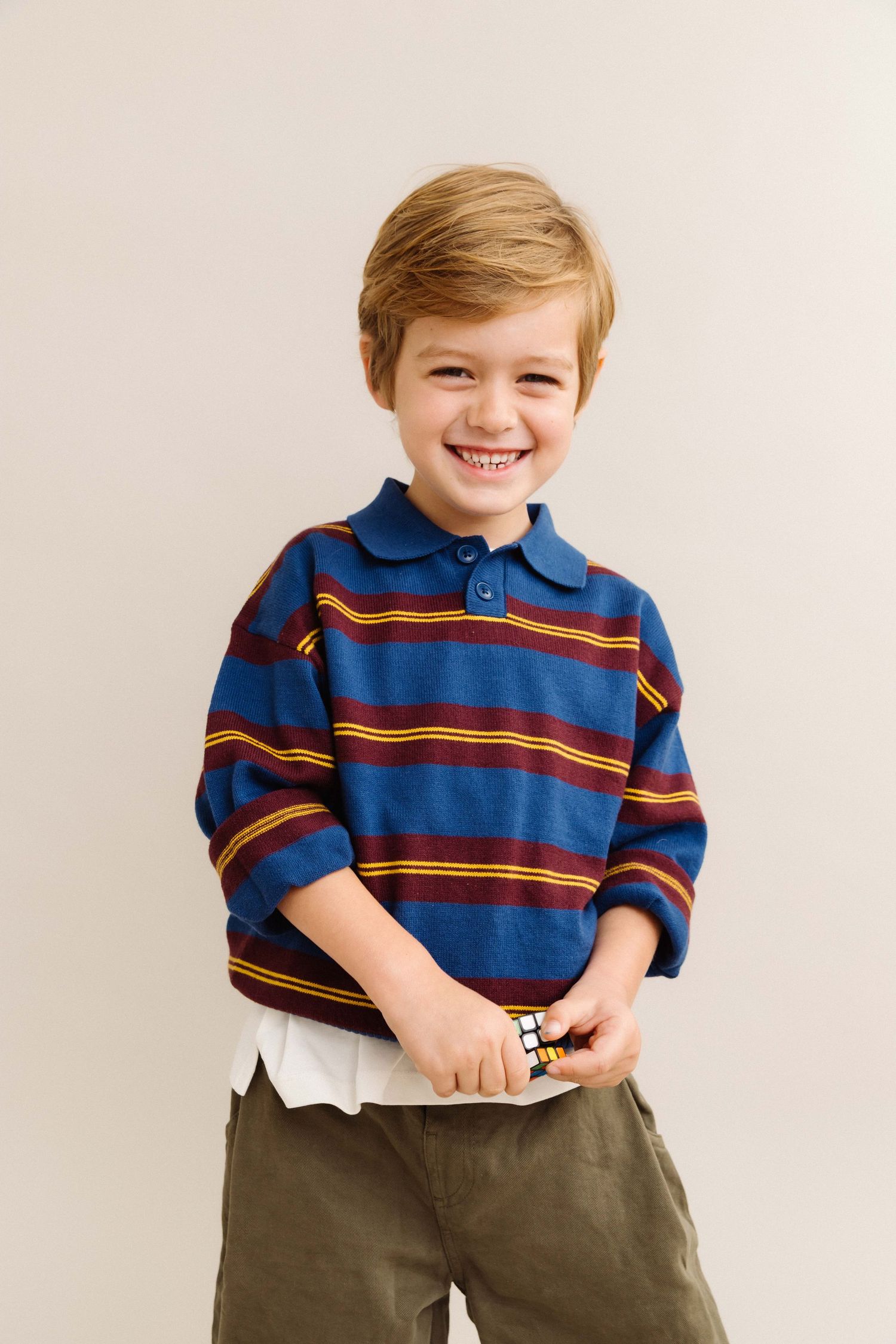 Editorial candid child portrait of kid smiling in a Santa Monica studio by Los Angeles family lifestyle photographer Phia Photography.