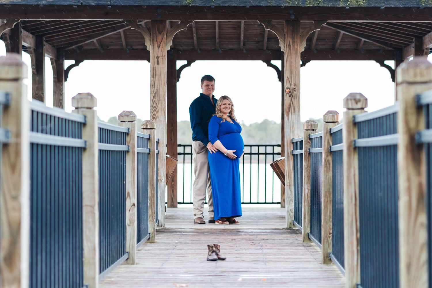 Mom and dad at Lake Warren in Hampton, SC. Baby boots in foreground.