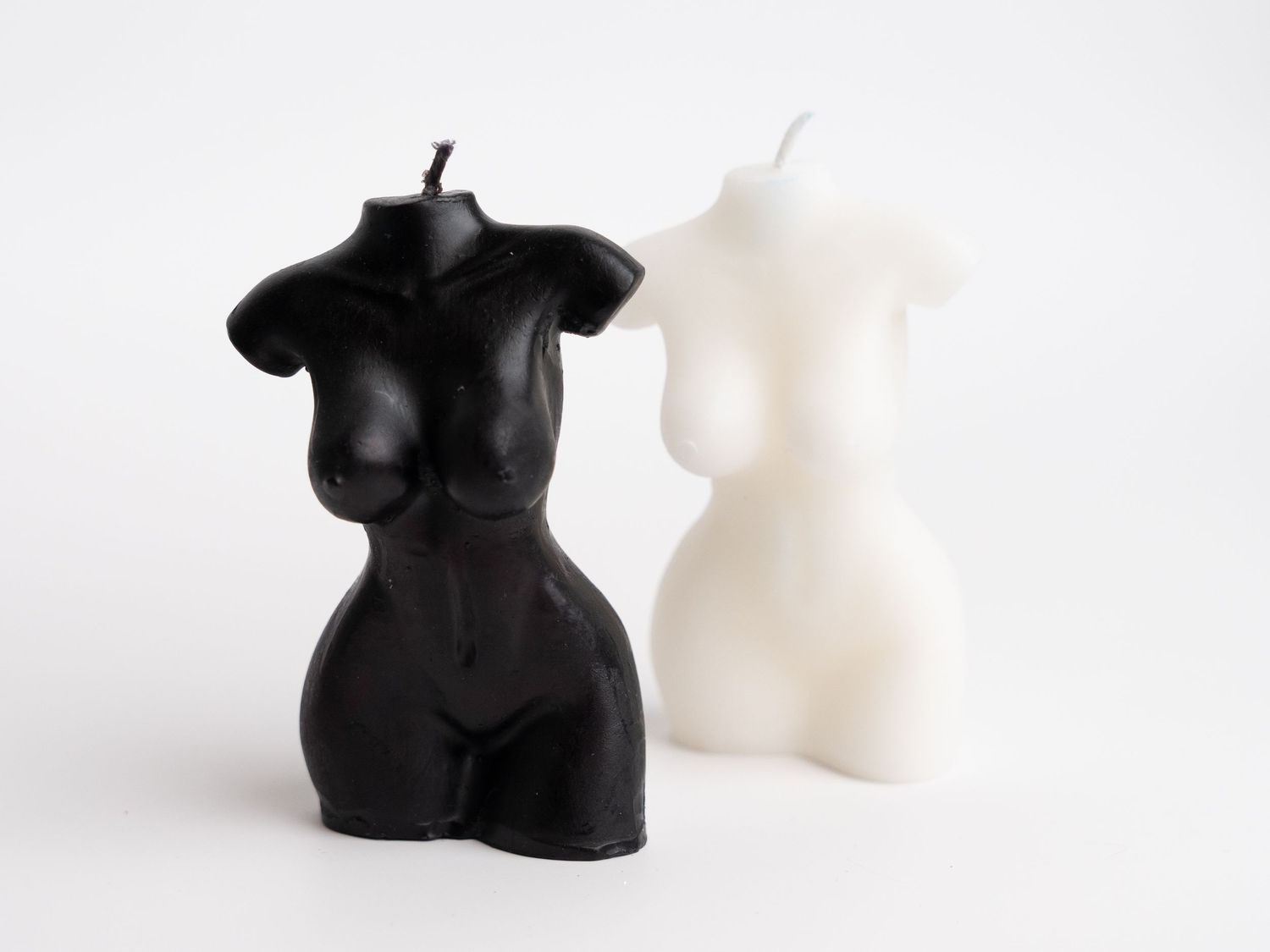 Minimalist black and white decorative figures displayed against white background.