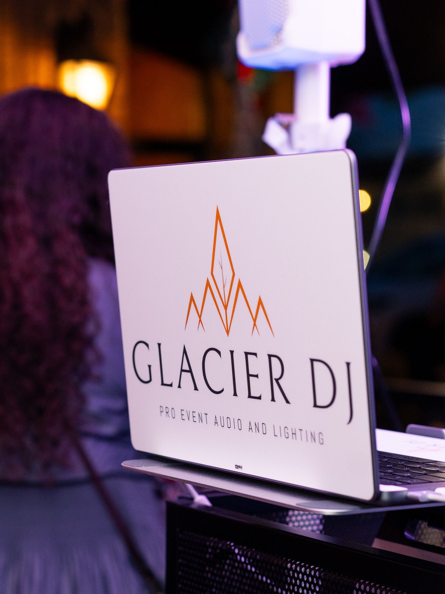 Glacier DJ event audio and lighting company logo display at night.
