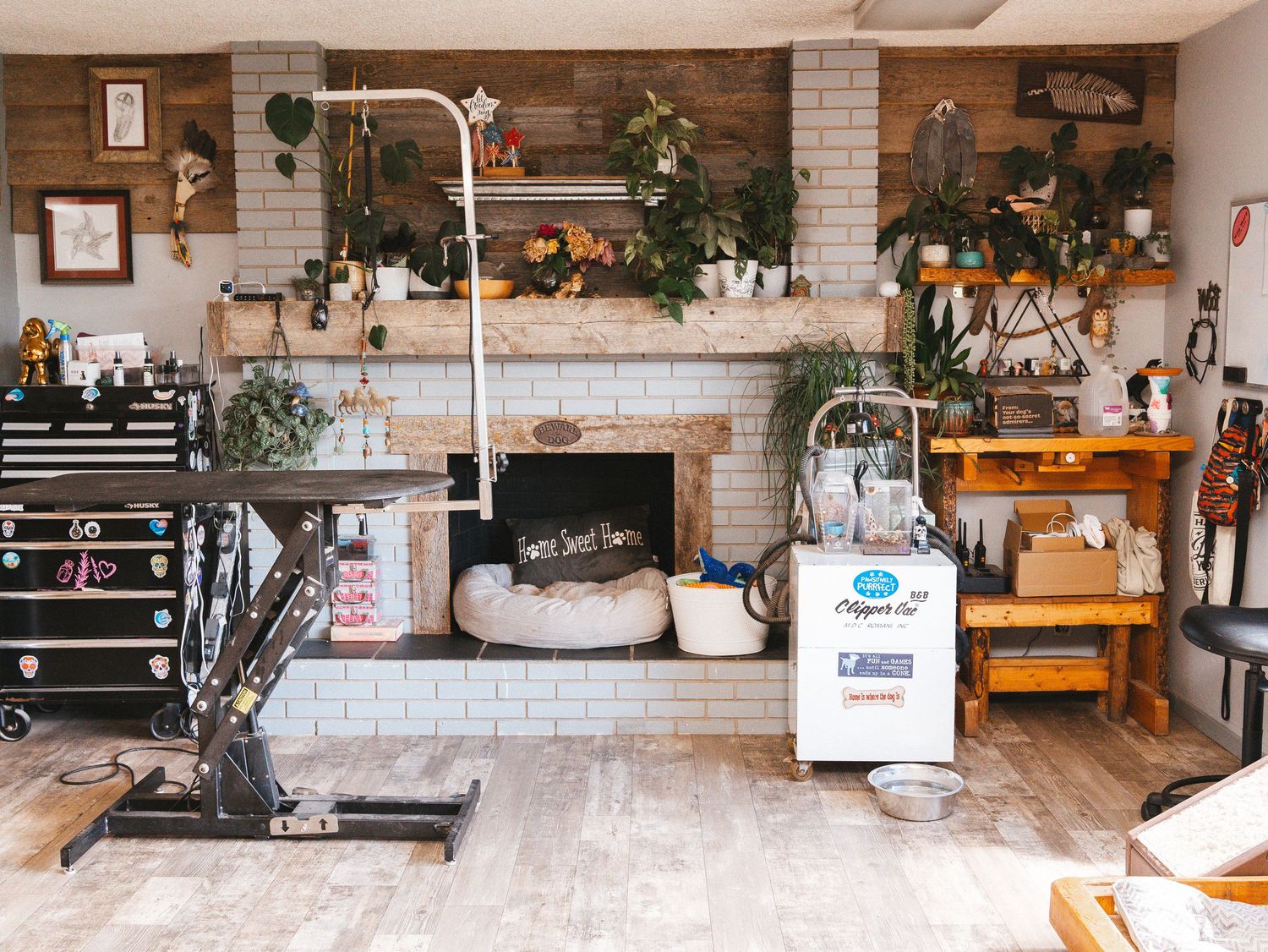 Rustic room interior with brick fireplace, wooden decor, and fitness equipment.