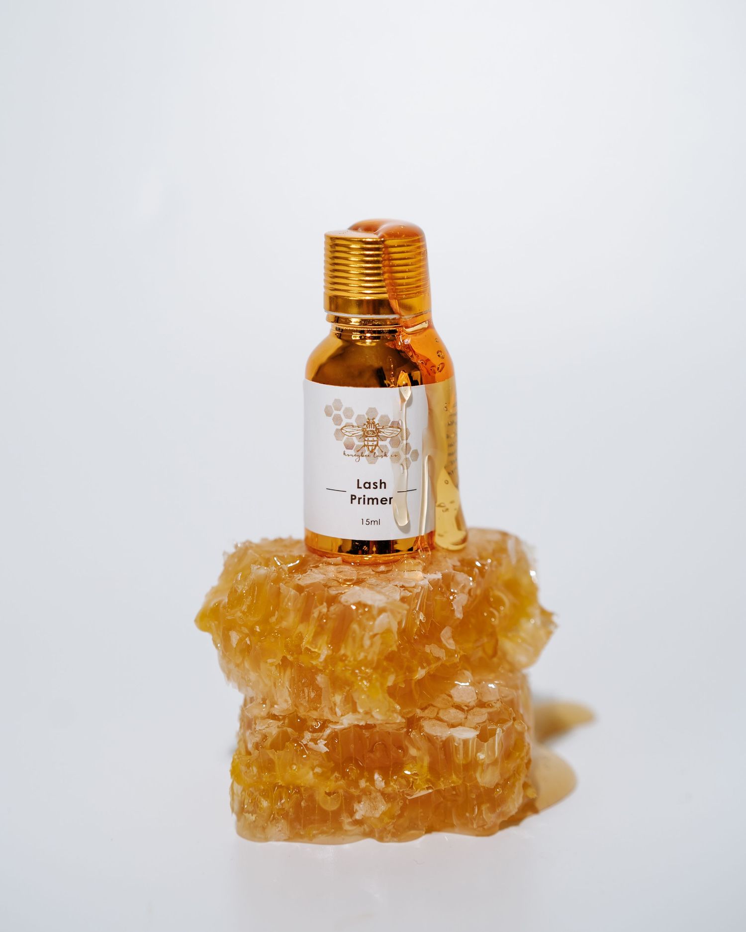 Small amber bottle displayed on crystalline honeycomb structure.