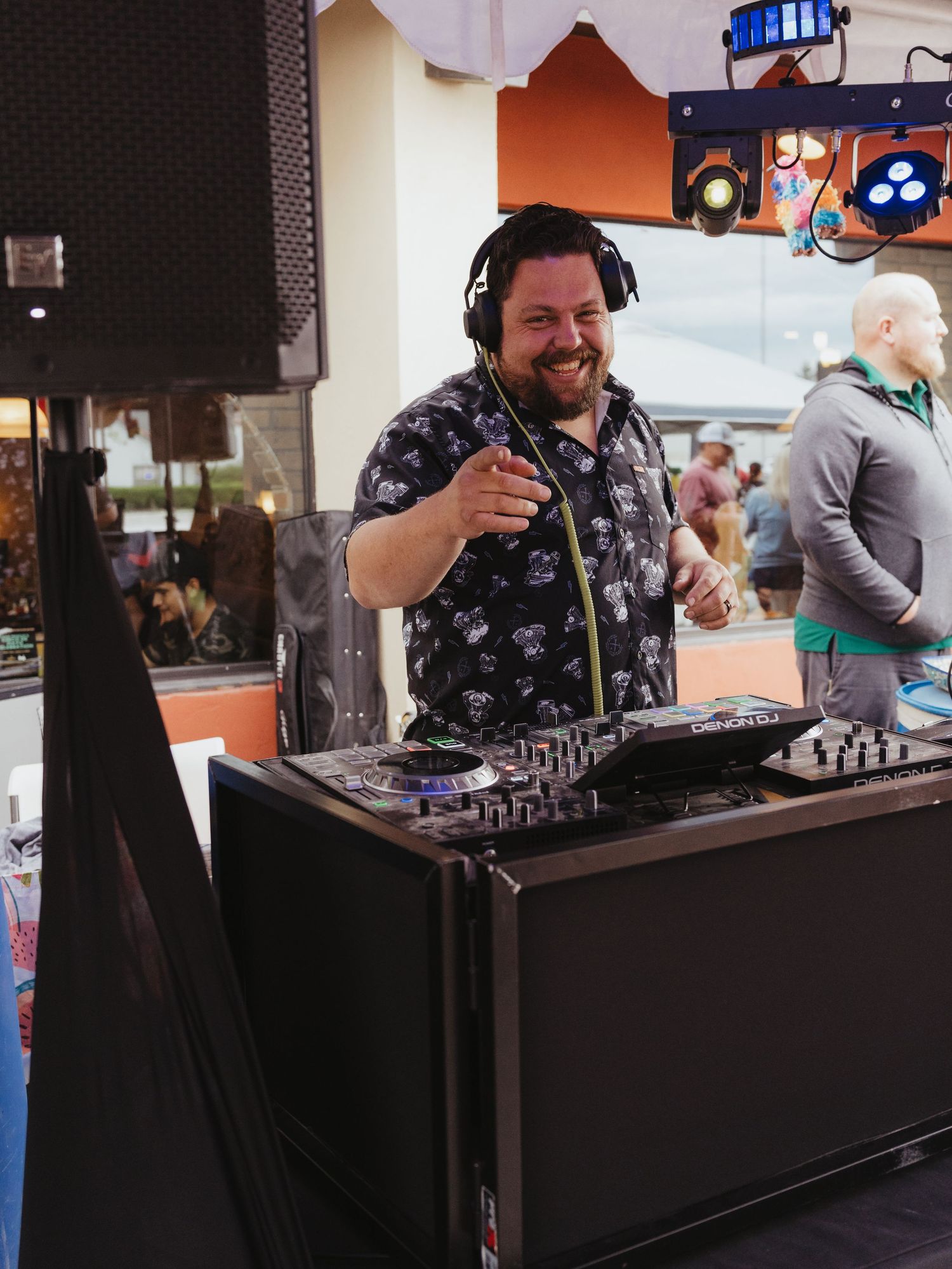 DJ performing at an event with professional audio equipment and headphones.