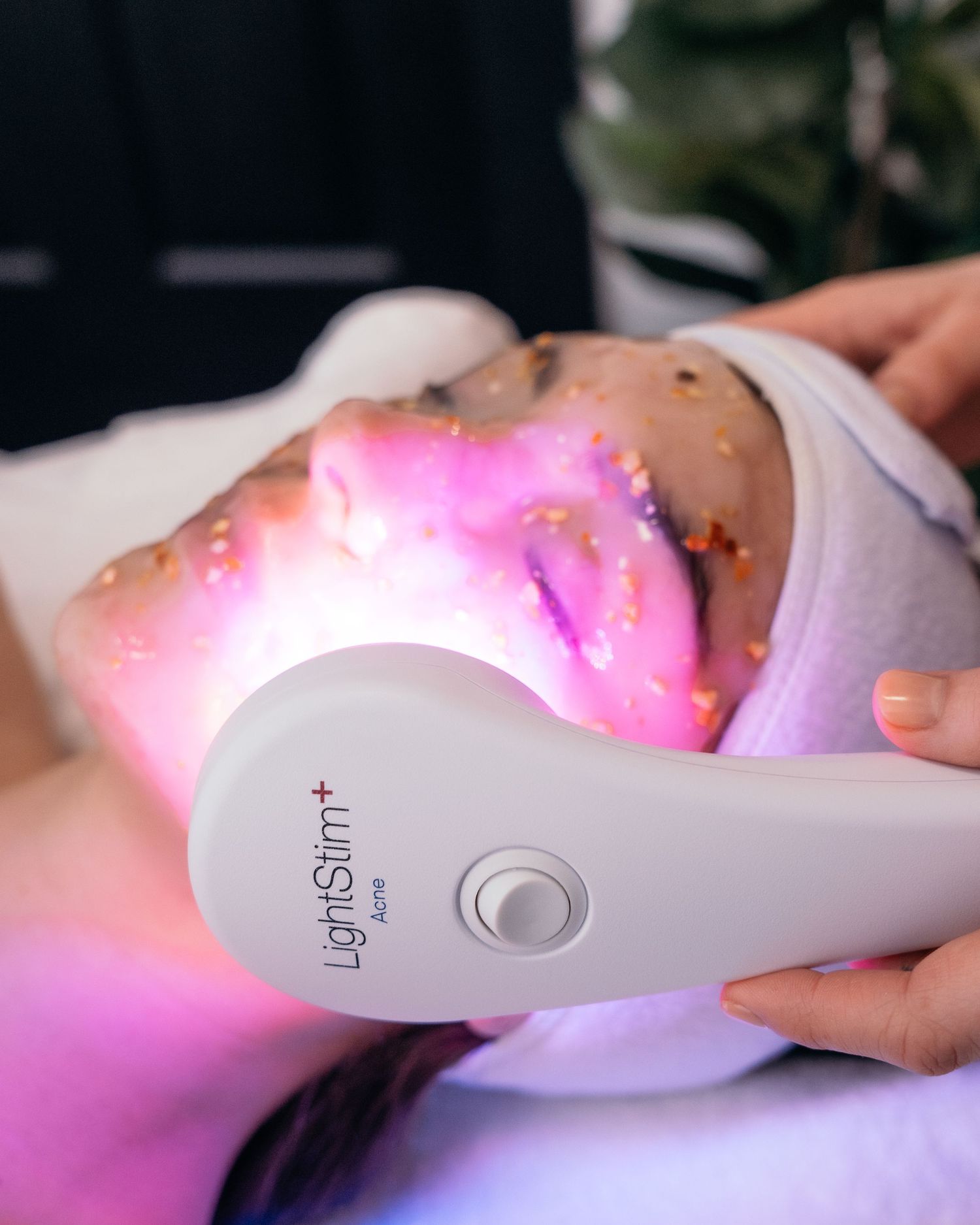 LED light therapy facial treatment using professional skincare device.