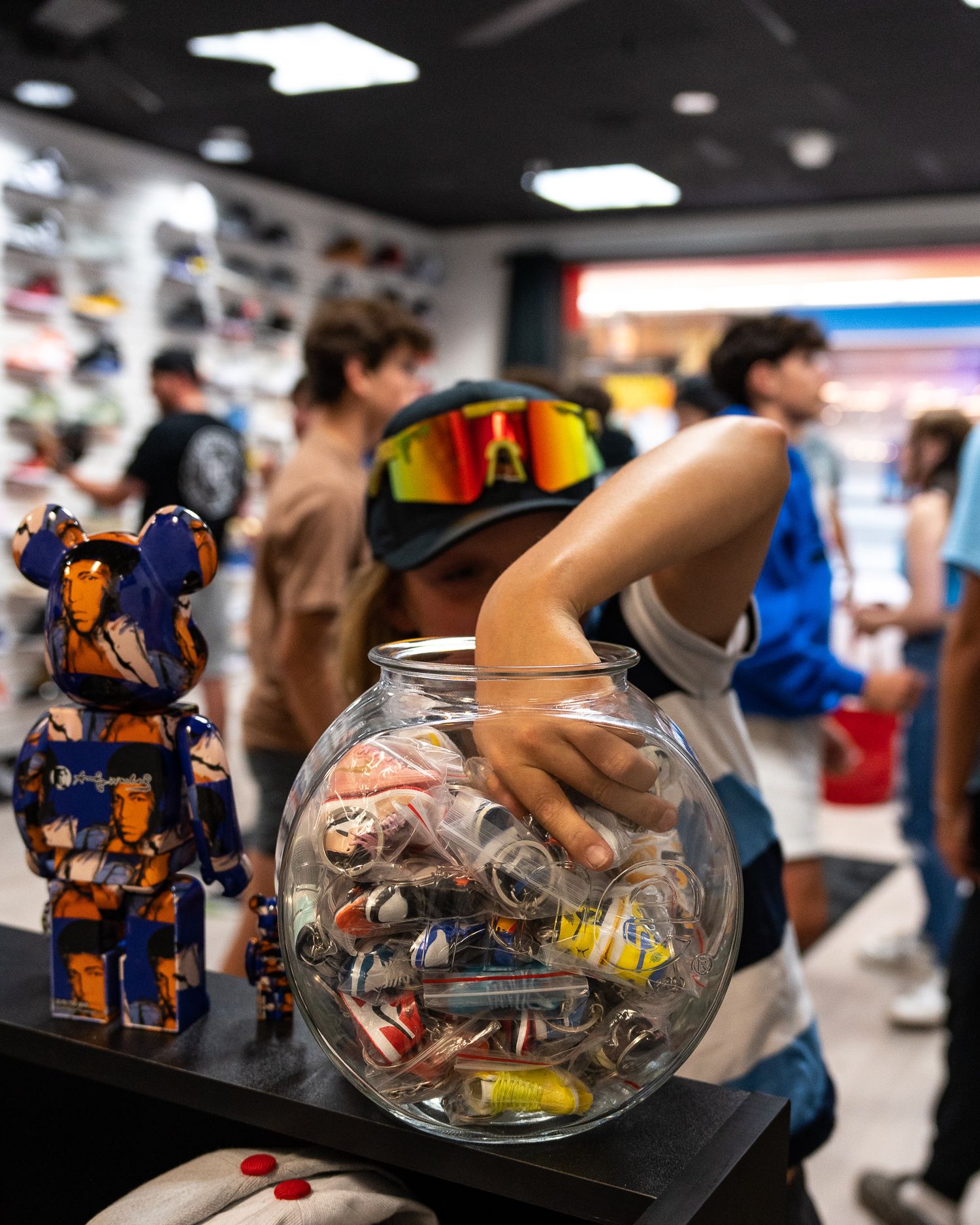 Collectible toys and figurines displayed in retail store with glass container centerpiece.