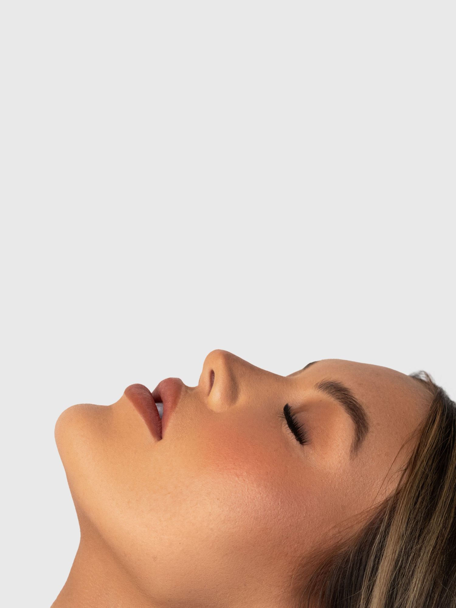 Minimalist profile portrait showing glowing skin and natural makeup.