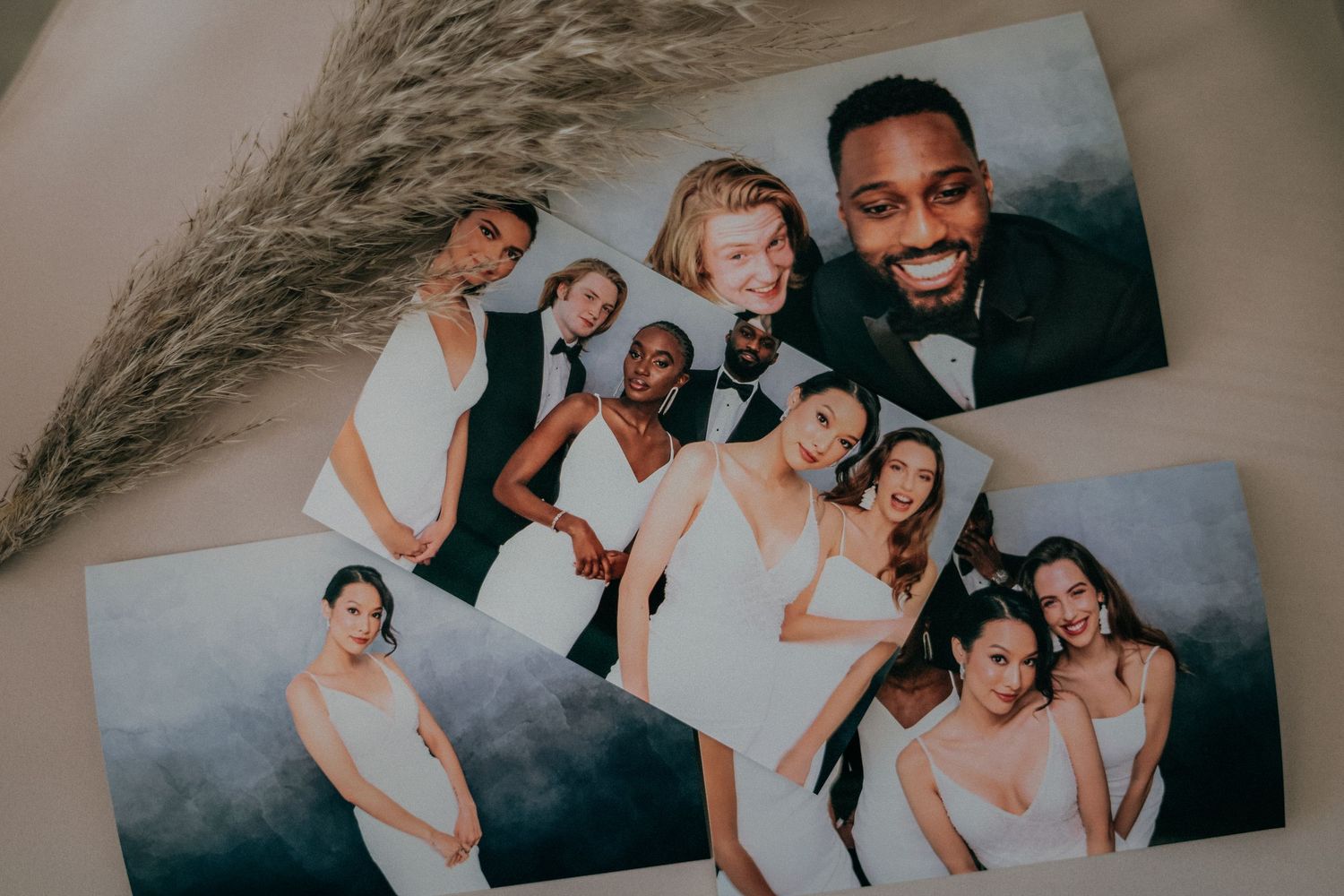 A group of friends laugh and embrace while taking casual candid photos together in a studio setting.