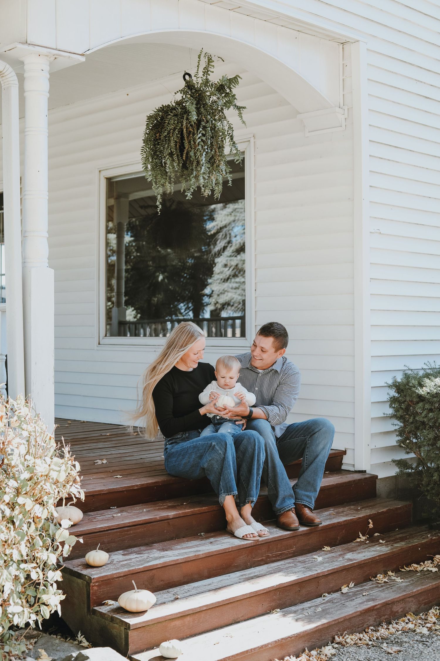 Parent and child sharing a tender moment on wooden porch steps.