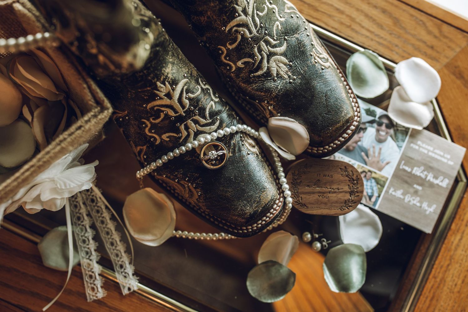 Detail shot of vintage style accessories and decorative items on wooden surface.