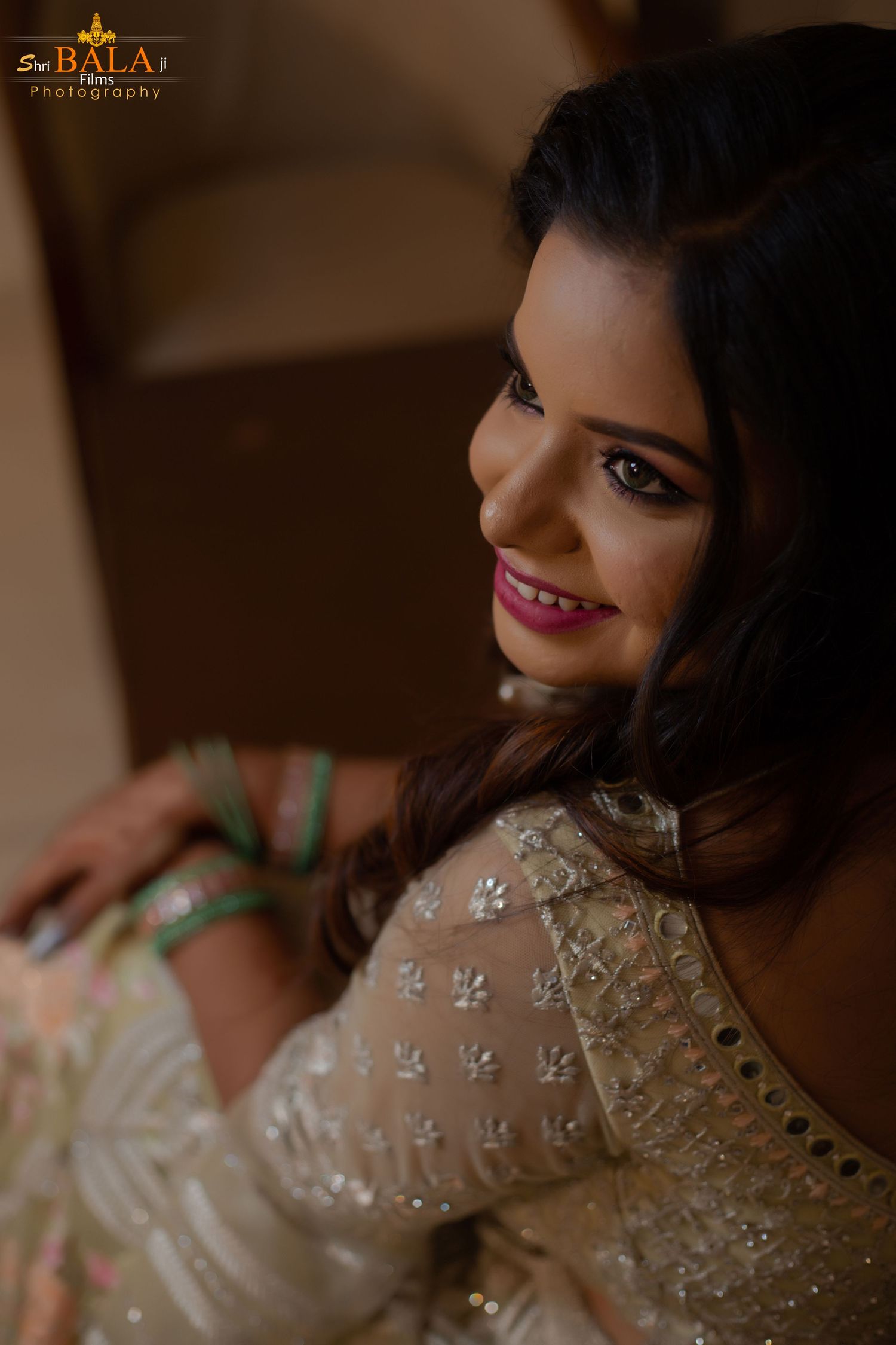 Close up portrait of bride in embellished cream outfit with soft lighting and romantic mood.