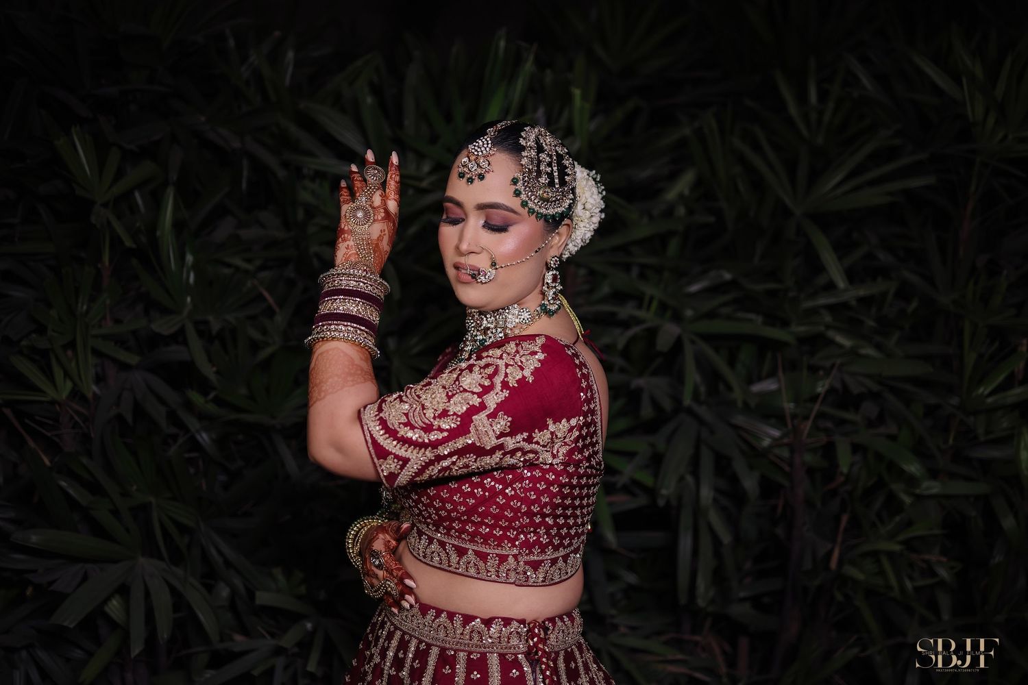 A person in traditional Indian bridal attire poses gracefully in multiple artistic shots against a dark background.