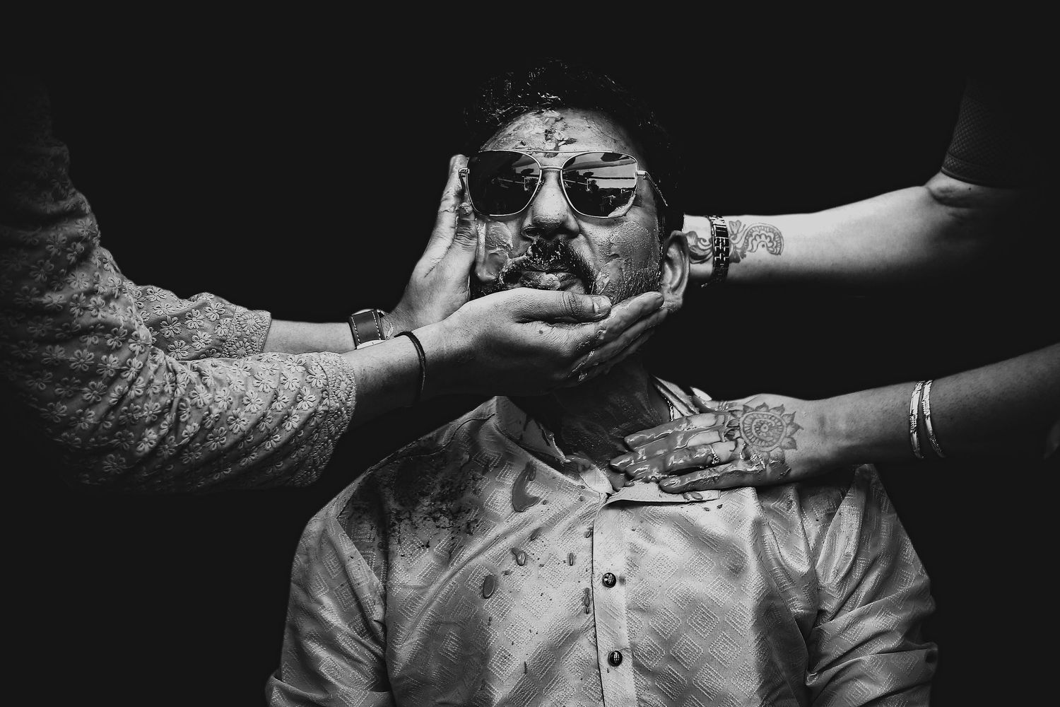 Artistic black and white photography showing hands reaching out in dramatic lighting.