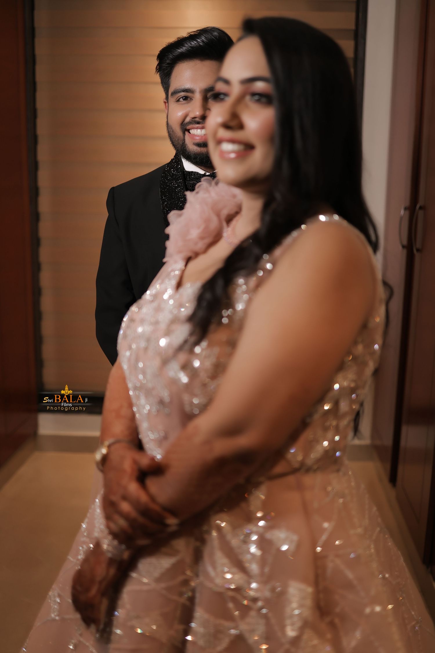 Elegant couple in formal attire sharing a romantic moment at their reception.