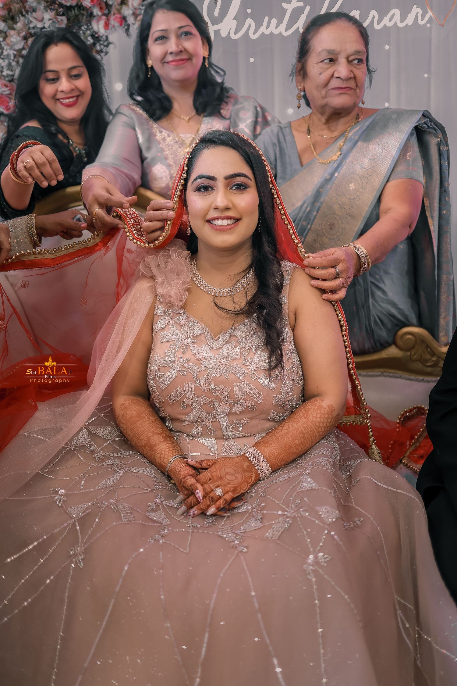 Intimate family moment during an Indian wedding ceremony with traditional dress and decor.